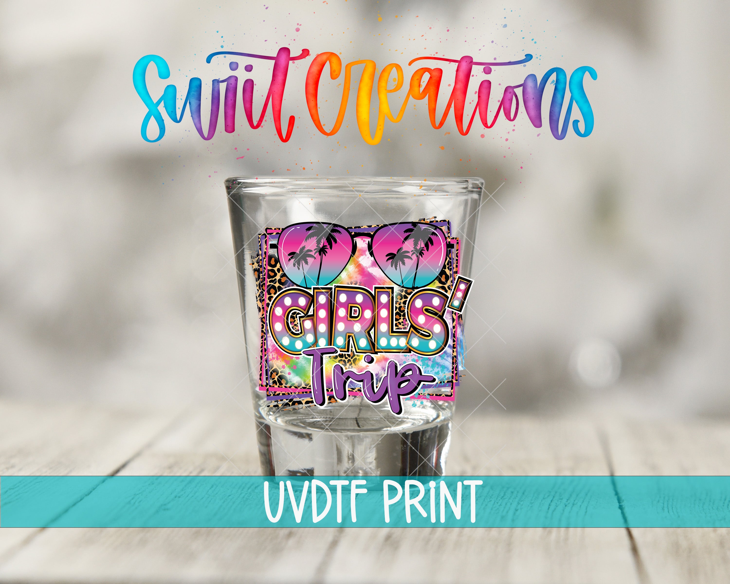A shot glass with a colorful design featuring a palm tree and the text "GIRLS TRIP" printed on it, along with the text "Swift Creations" and "UVDF PRINT" printed below.