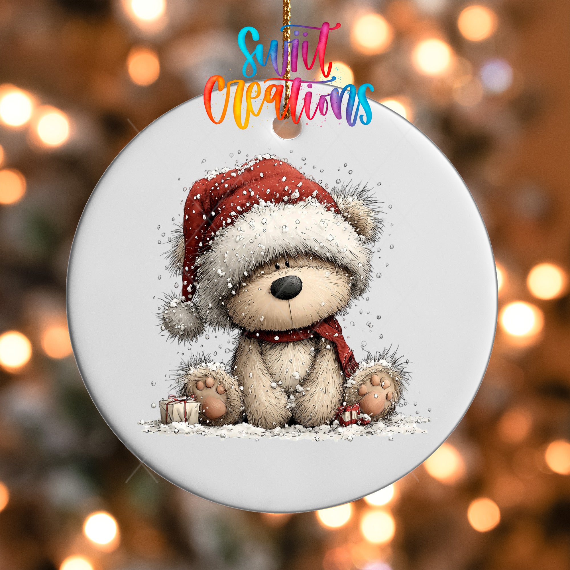 A white ornament with a teddy bear wearing a red Santa hat and scarf, sitting on a snowy surface.