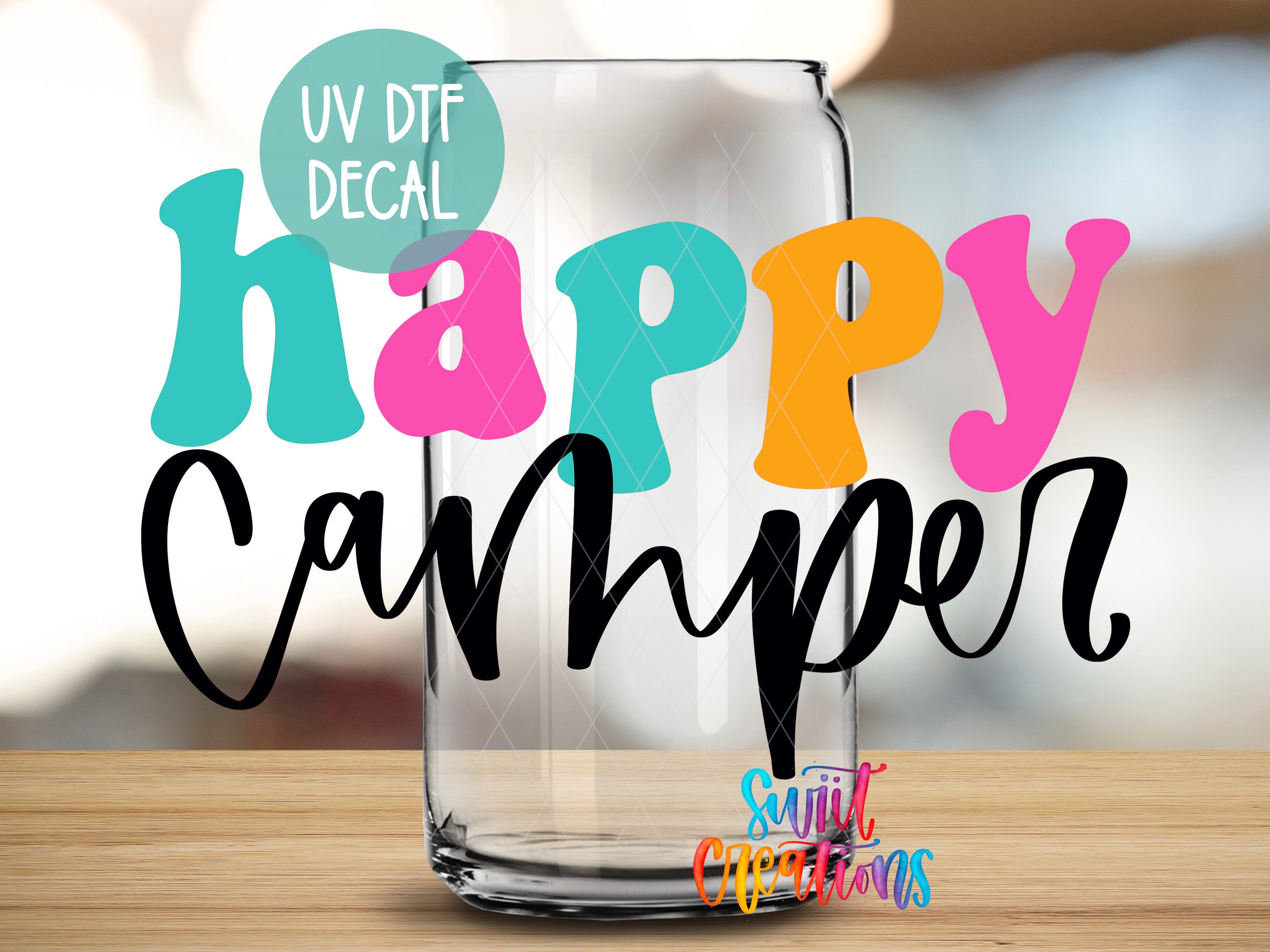 a happy camper glass sitting on top of a wooden table