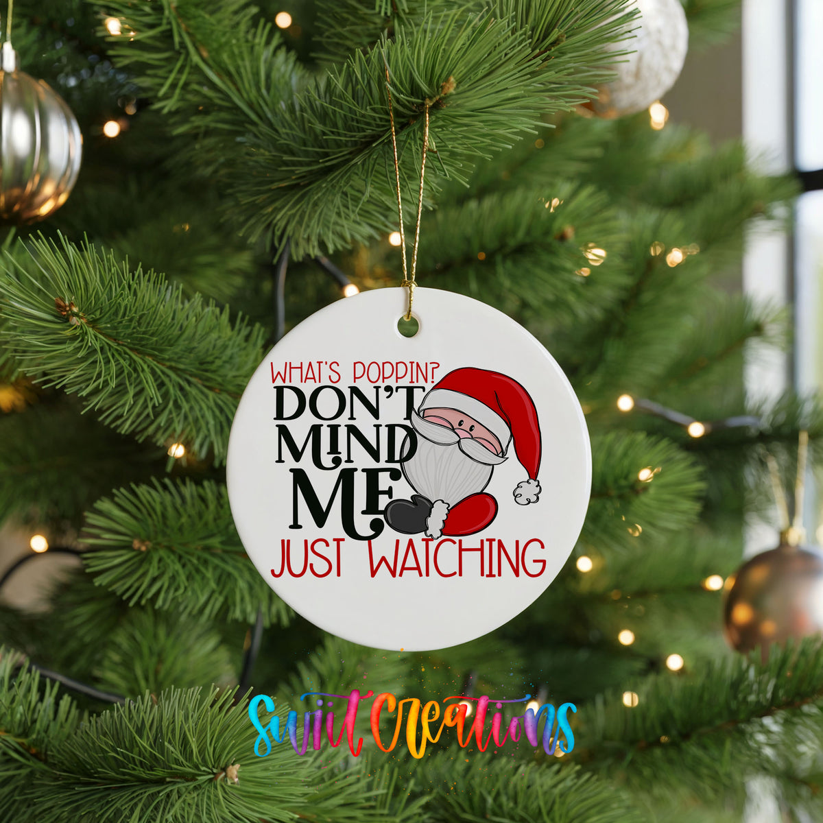 A white Christmas tree ornament with a Santa Claus image and text that reads "What's poppin? Don't mind me just watching".