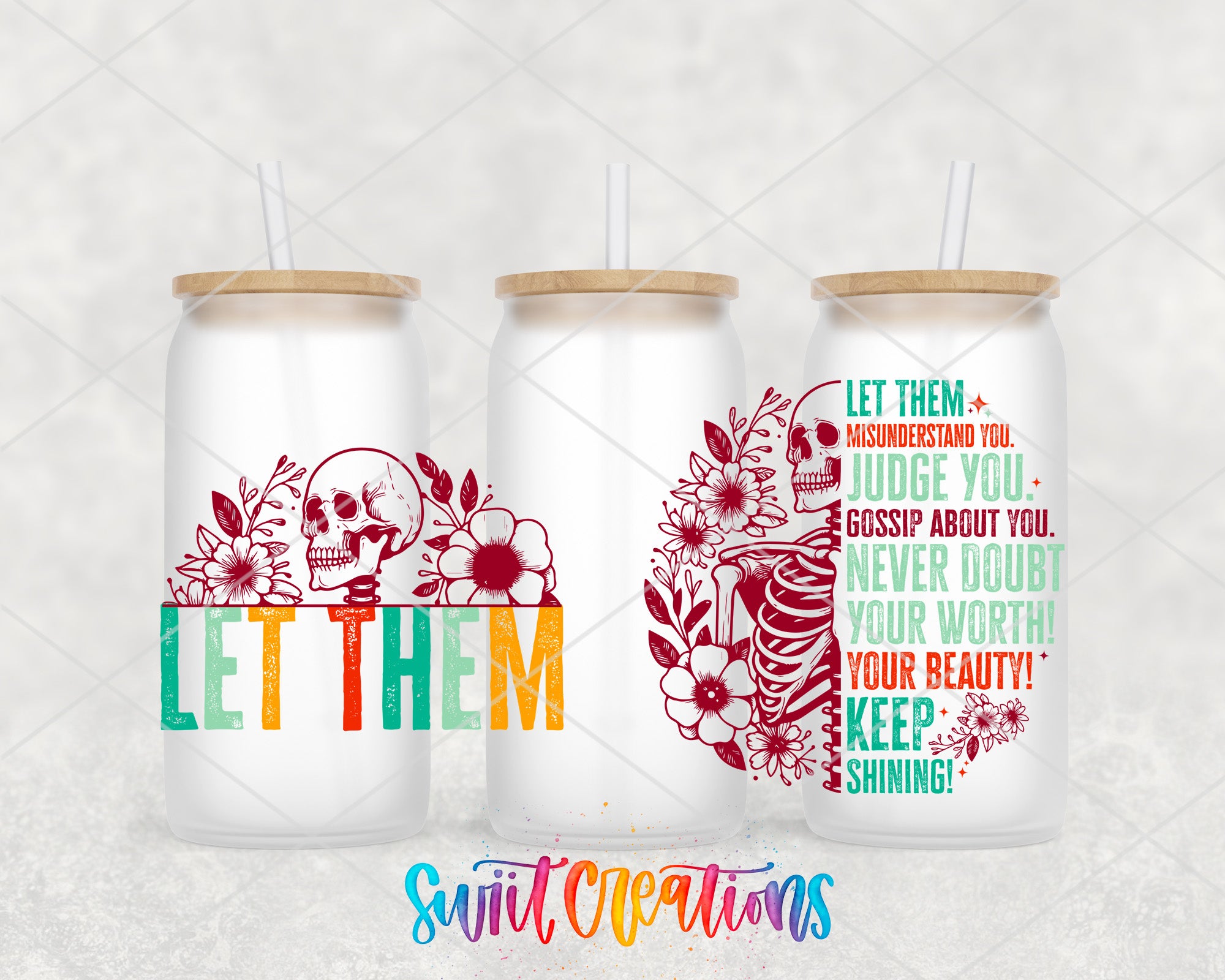 three colorful glass tumblers with text and floral designs on them.