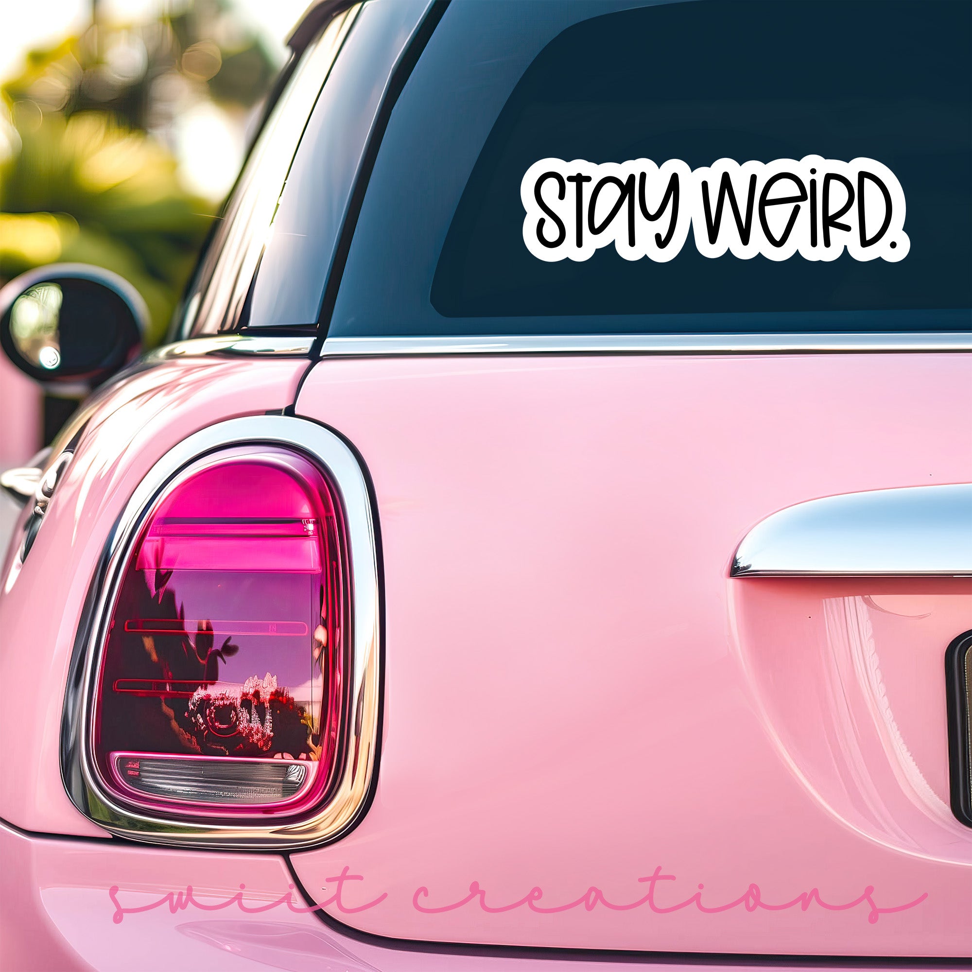 a pink car with a sticker that says stay weird