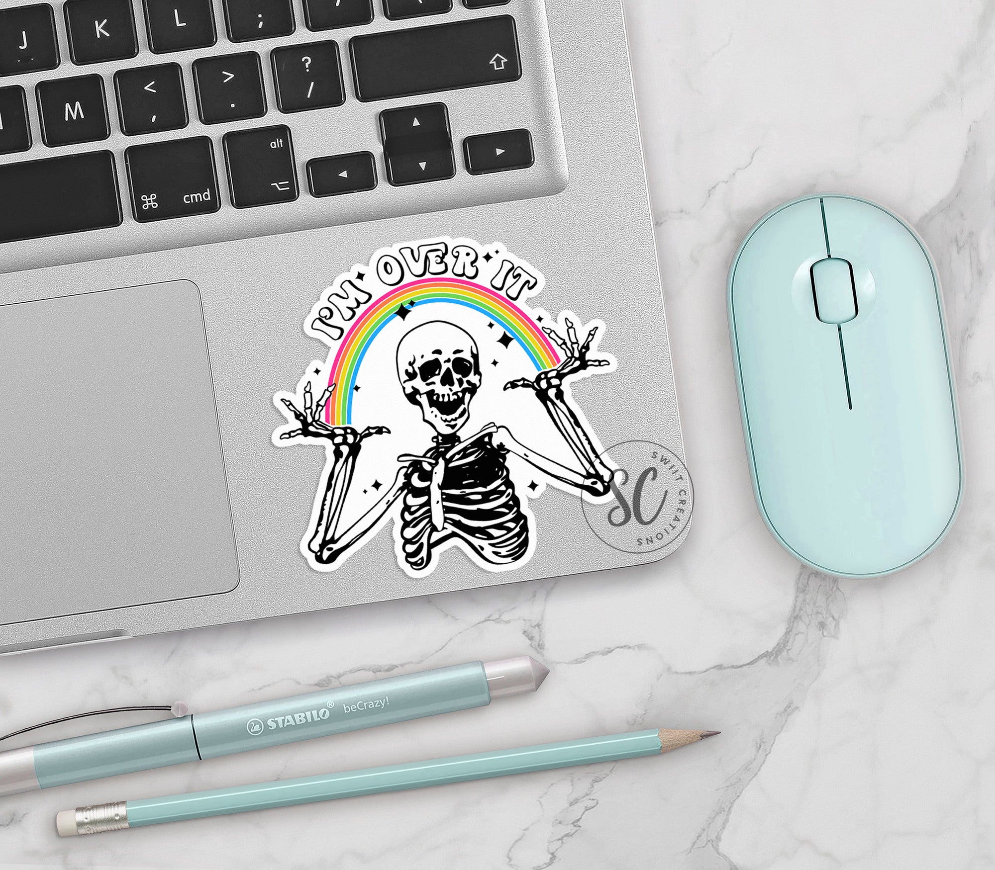 a laptop with a sticker of a skeleton holding two swords