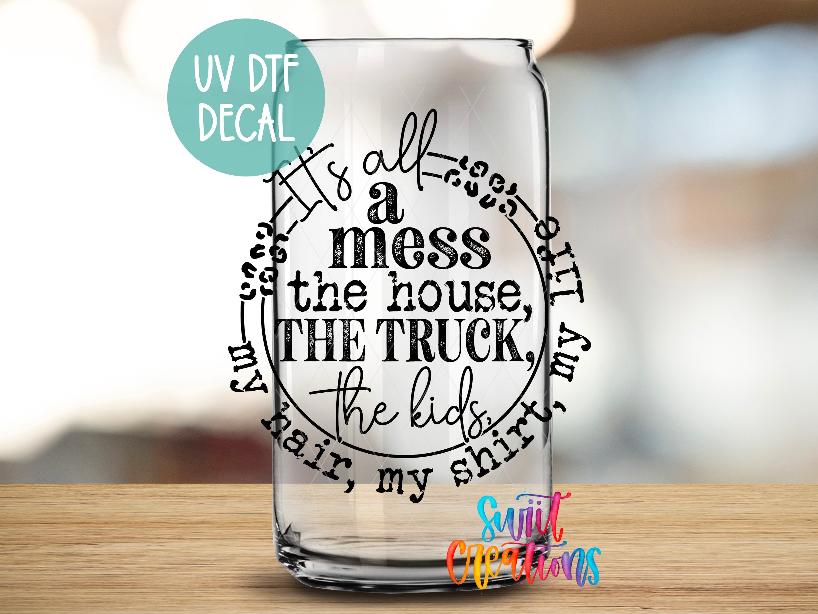 a glass with a quote on it sitting on a table