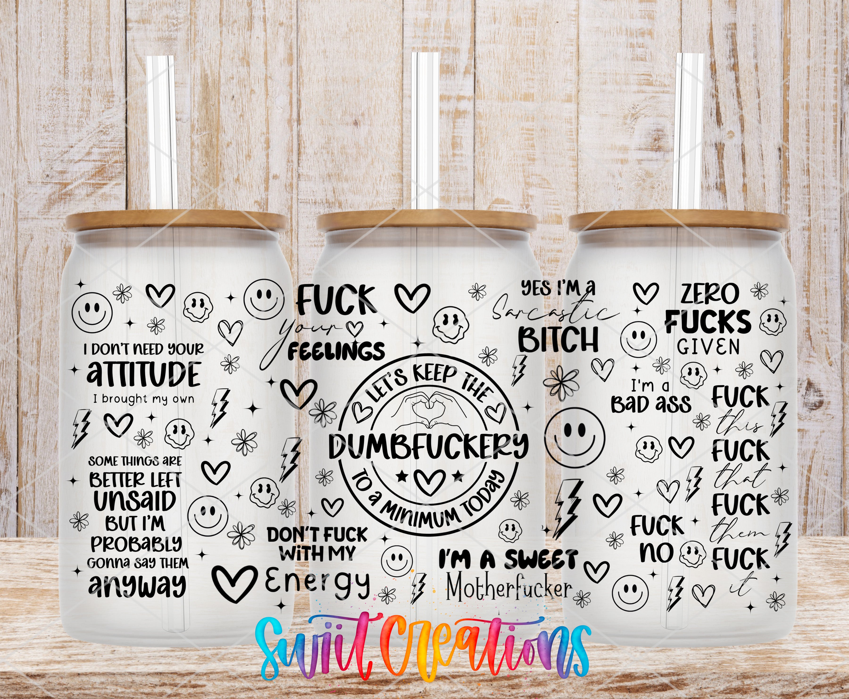 three glass tumblers with various sayings and designs printed on them.