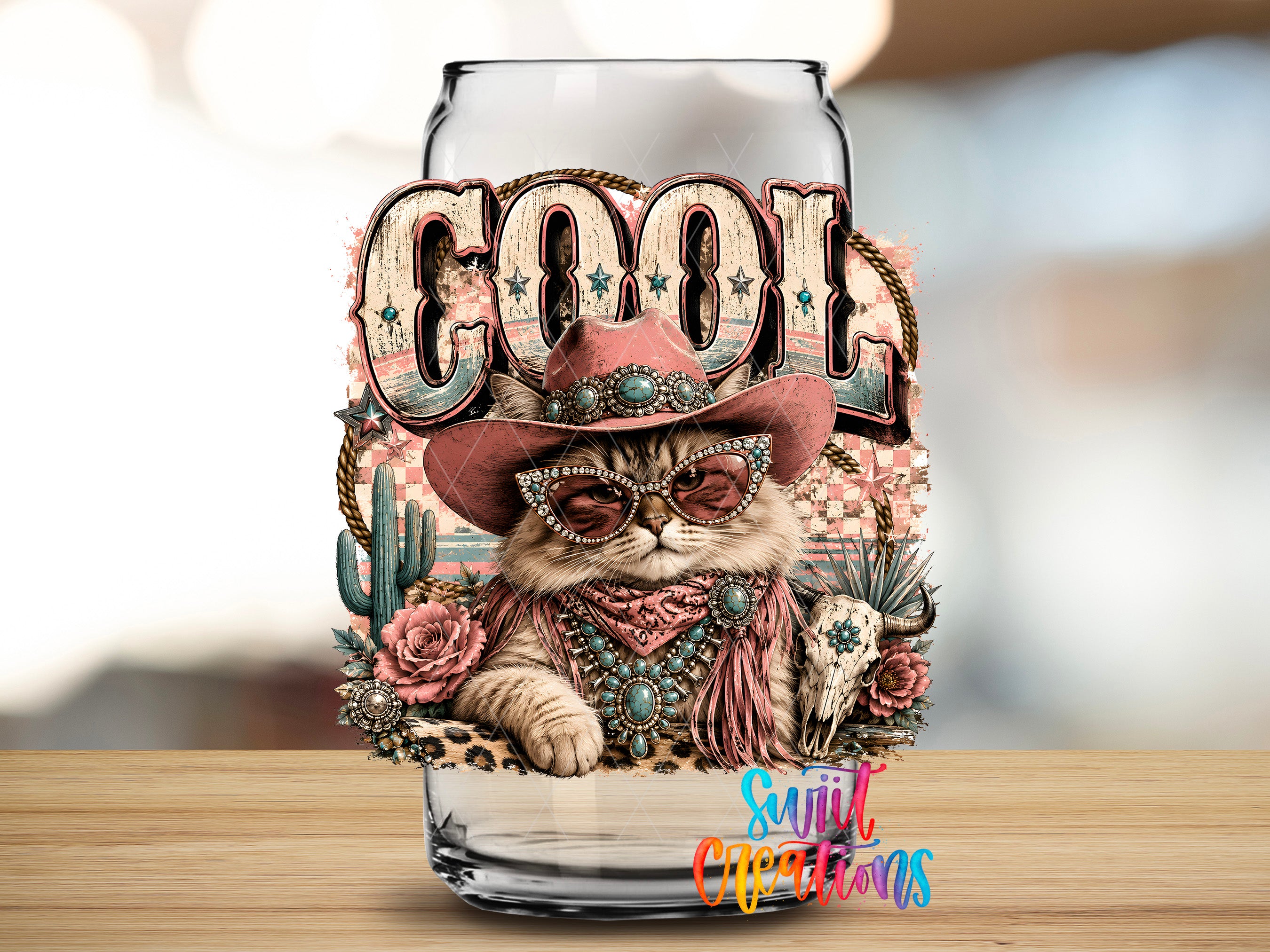 A glass jar with a cat wearing sunglasses and a cowboy hat, surrounded by various decorative elements such as flowers, cacti, and a skull.