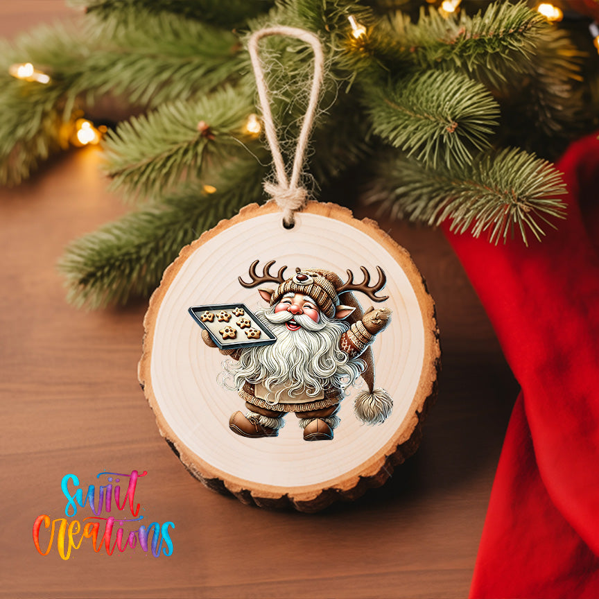 A wooden ornament featuring a cartoon image of Santa Claus holding a tray of cookies, hanging on a Christmas tree.