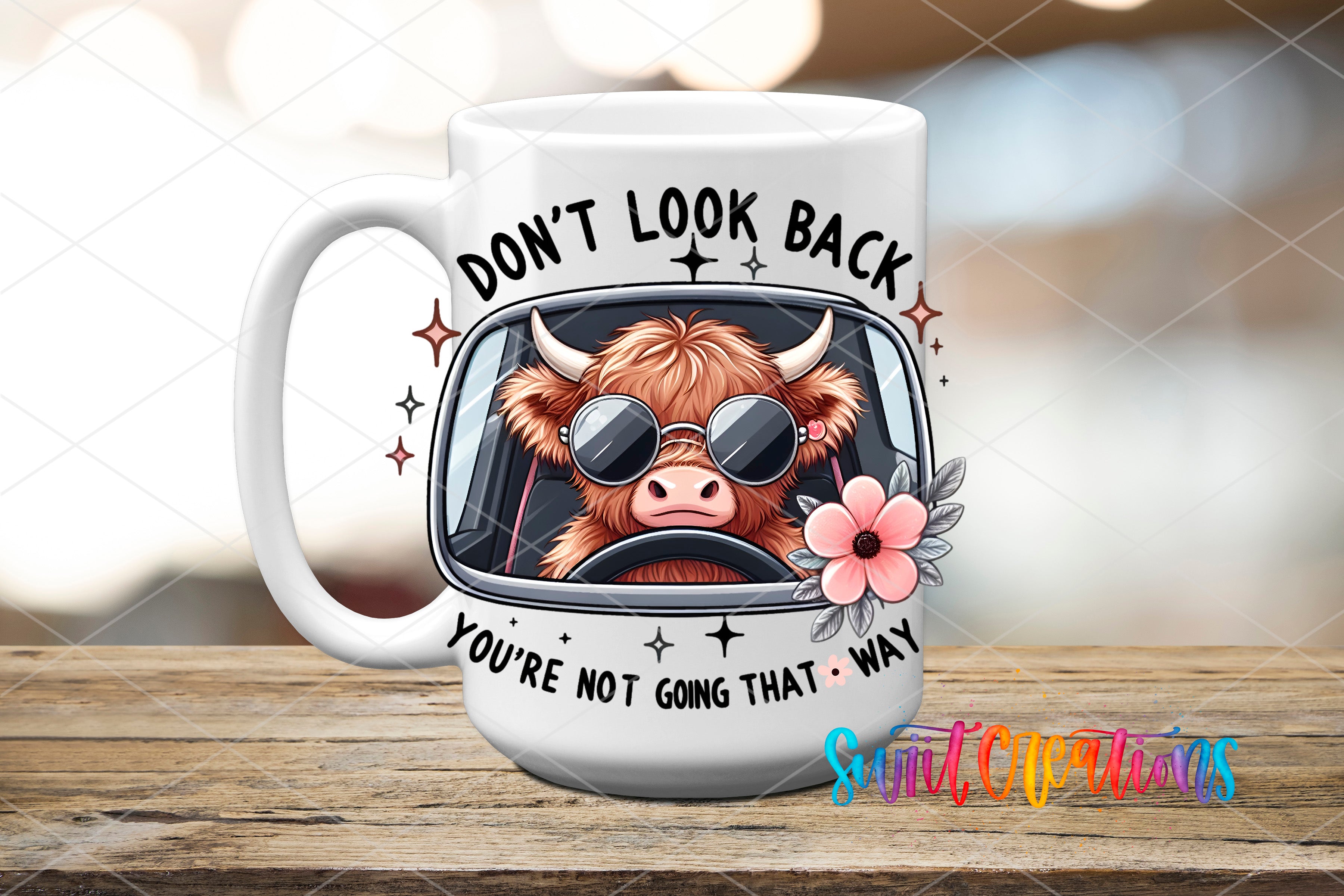 A white mug with a cartoon image of a horned cow wearing sunglasses and a flower, along with the text "DON'T LOOK BACK YOU'RE NOT GOING THAT WAY" printed on it.