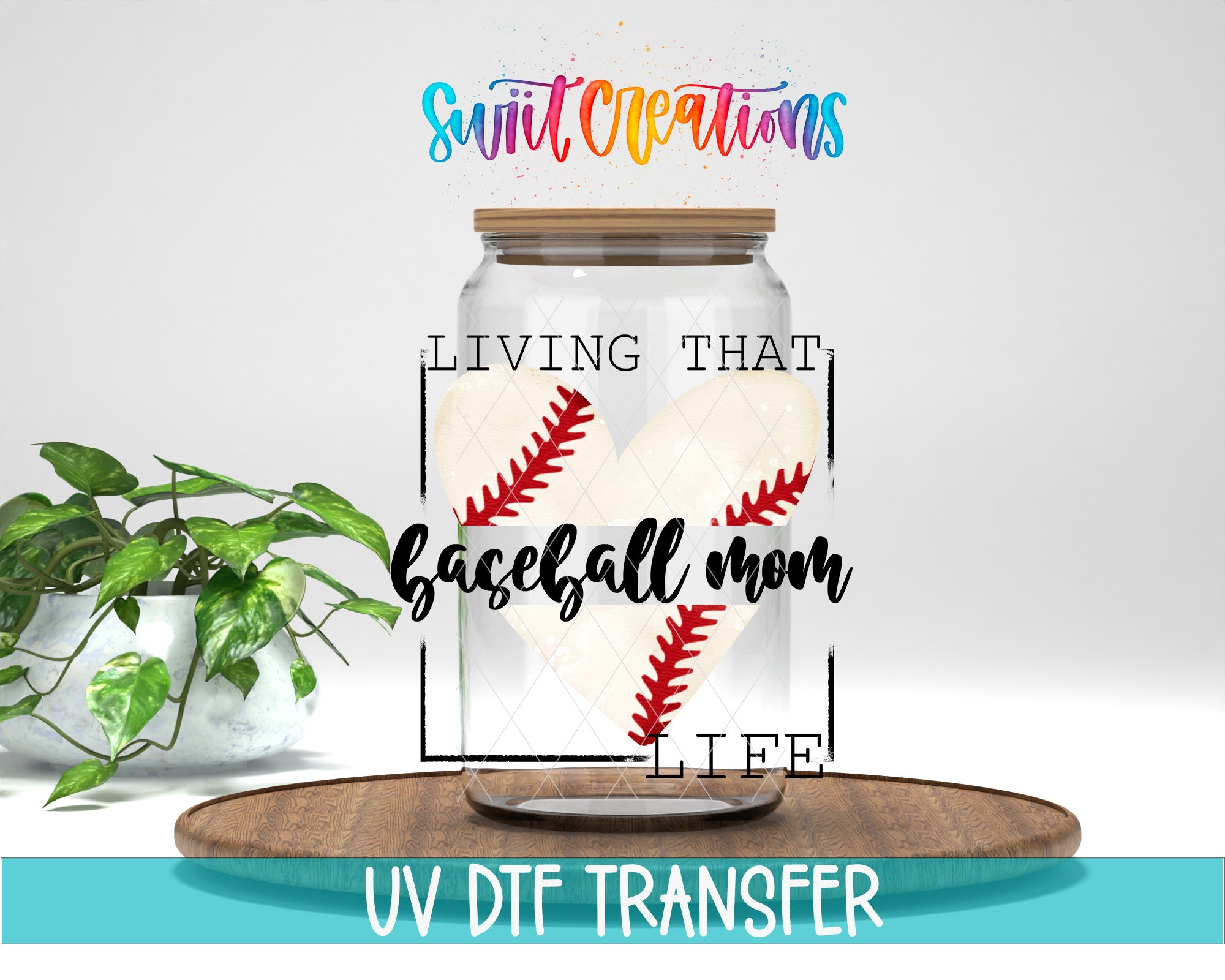 a glass jar with a baseball design inside, placed on a wooden surface. The jar has a lid and a label that reads "LIVING THAT BASEBALL MOM LIFE". There is also a plant in the background.