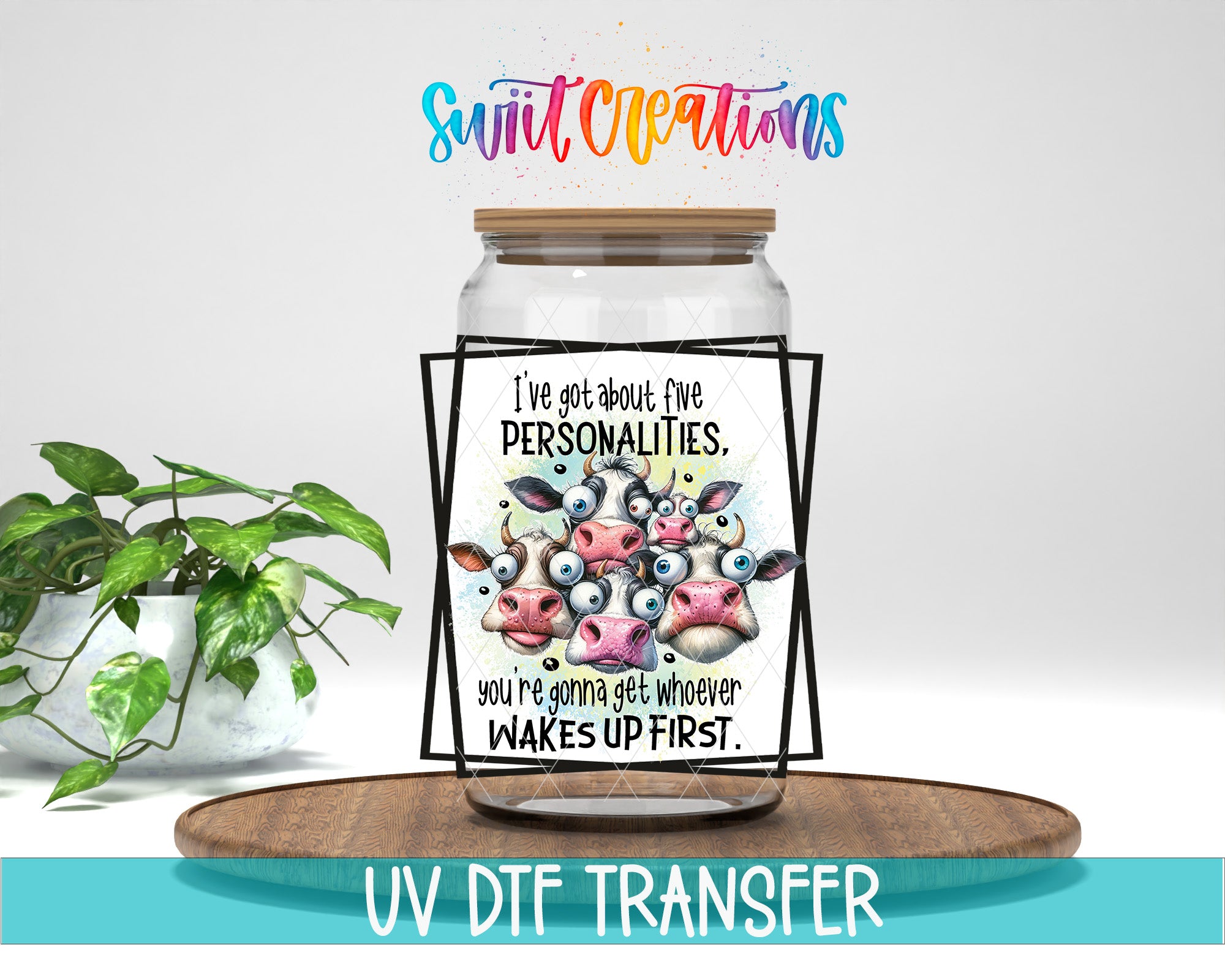 A jar with a label featuring a cartoon cow and the text "I've got about five personalities. You're going to get whoever wakes up first." The jar is placed on a wooden tray, and there is a potted plant in the background.