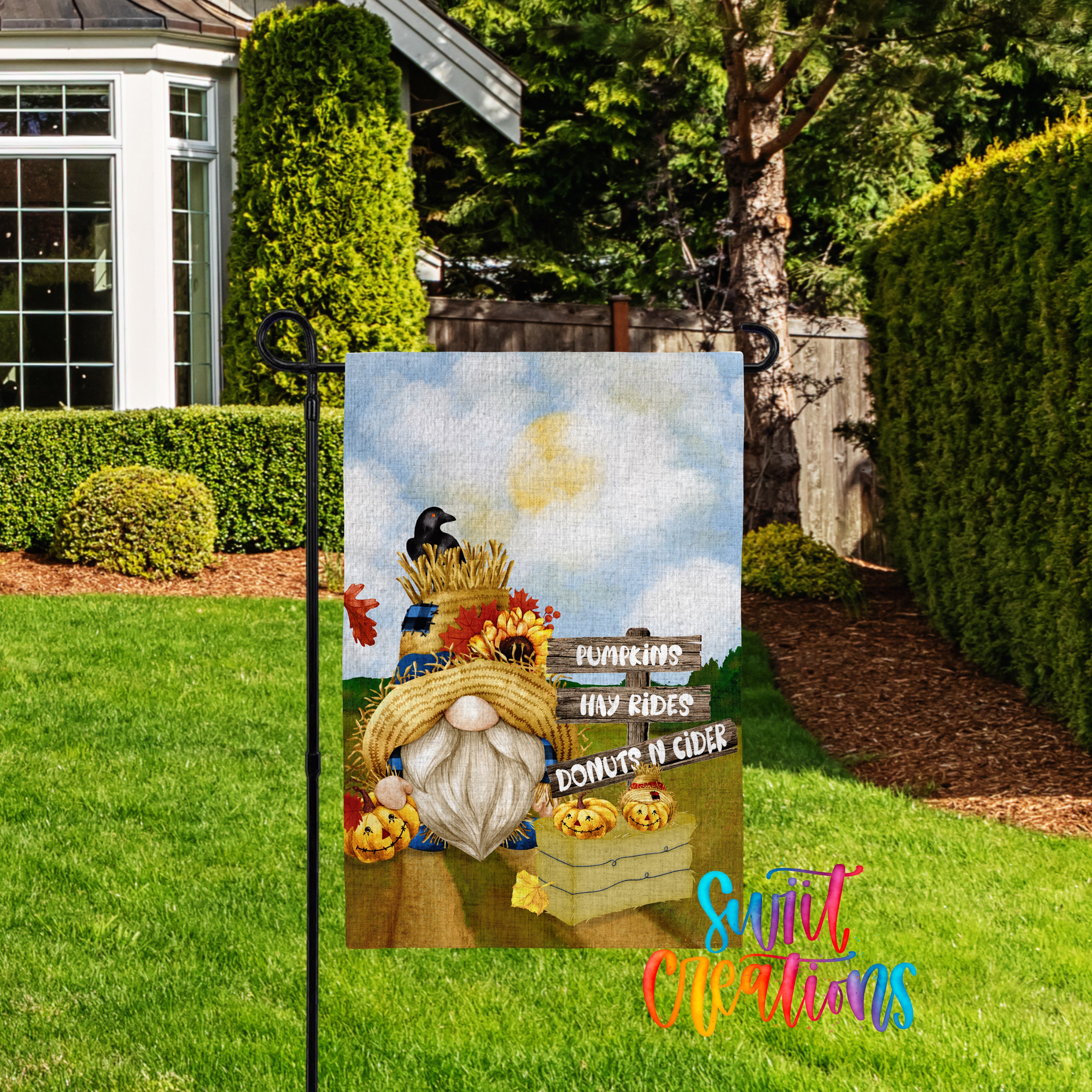 A garden sign featuring a gnome holding a basket of autumn fruits, including pumpkins and apples, with a sign that says "Pumpkins, HAY RIDES, DONUTS IN CIDER".