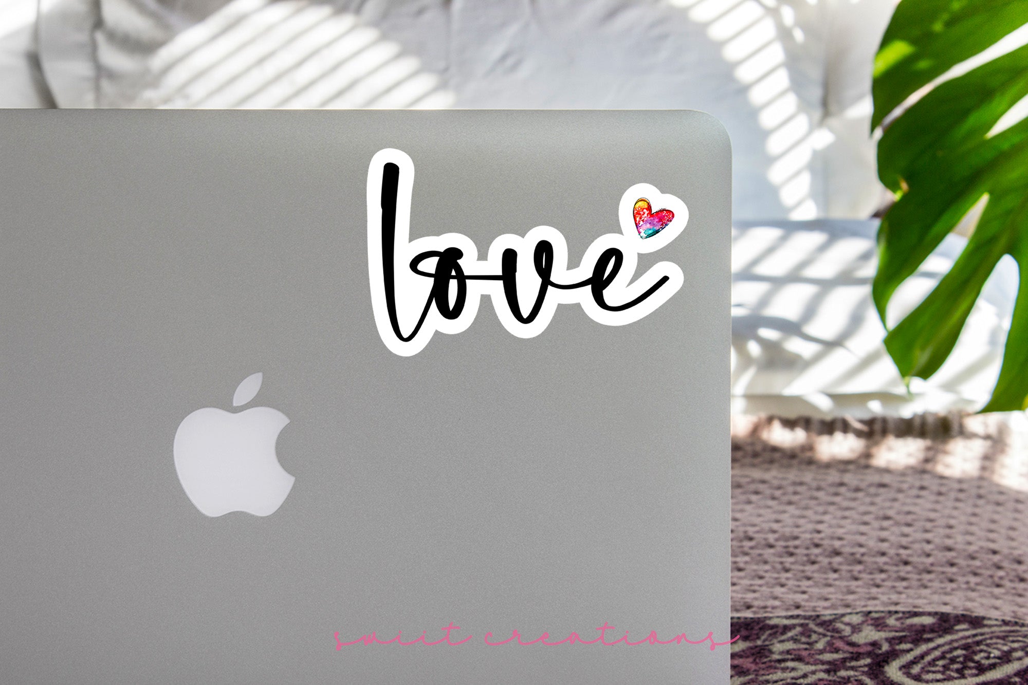 a laptop with a sticker that says love on it