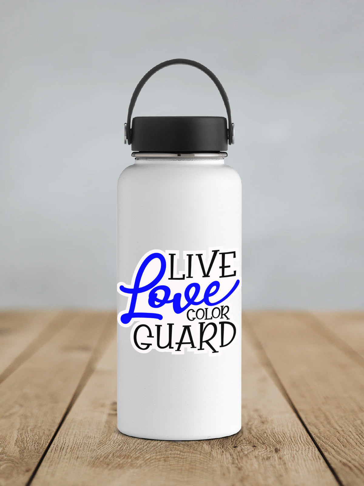 a white water bottle sitting on top of a wooden table