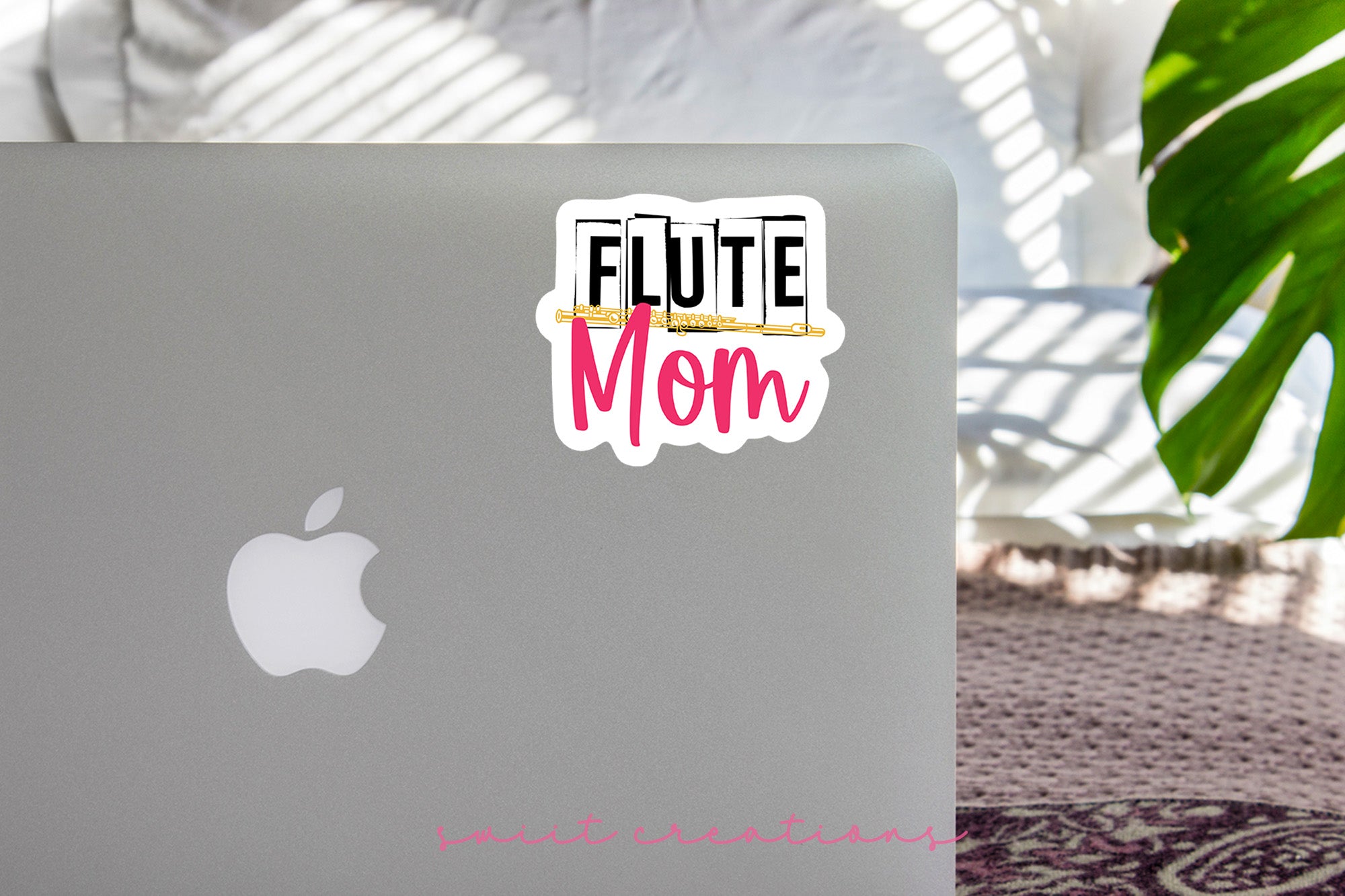 a laptop with a sticker that says flute mom