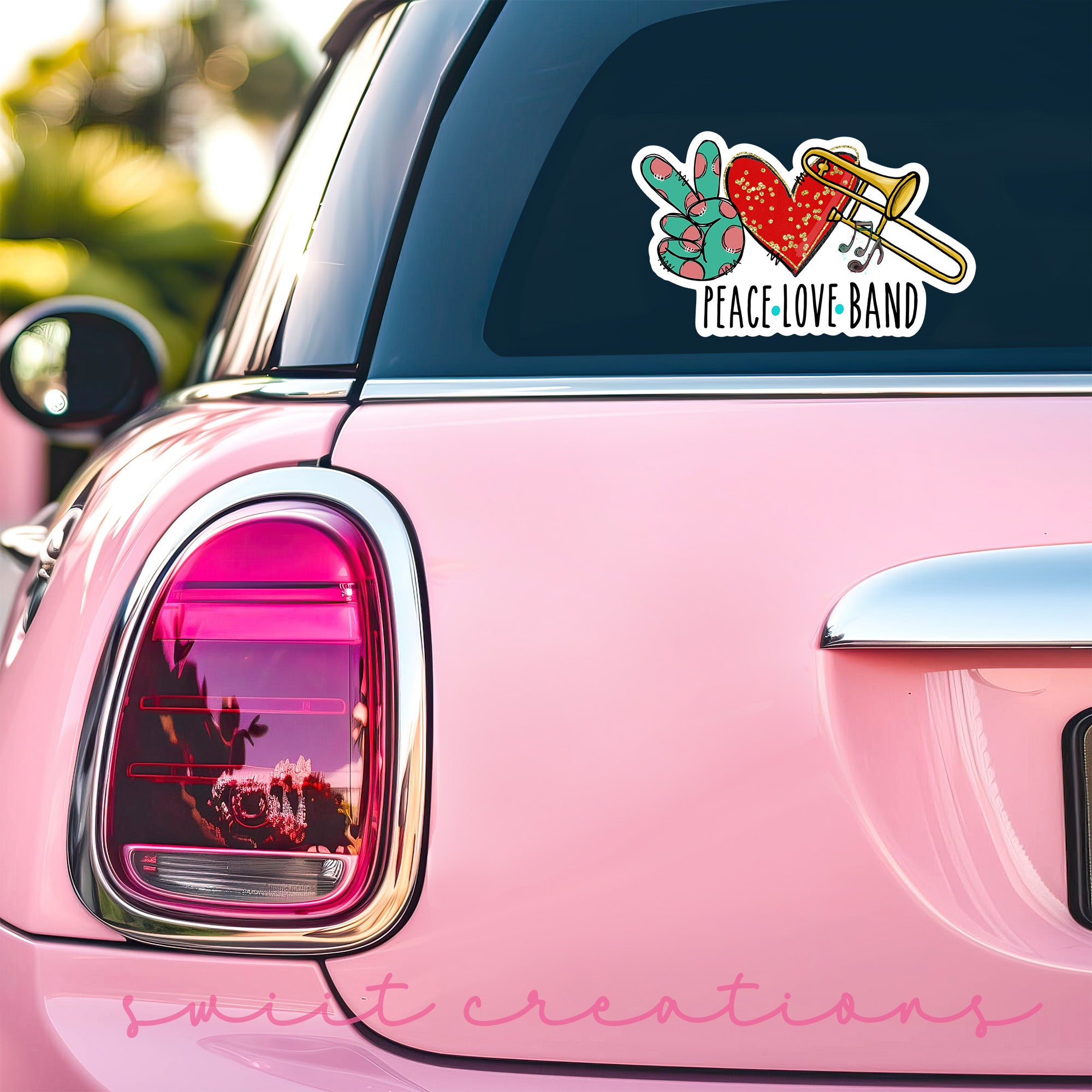 a pink car with a peace love band sticker on it