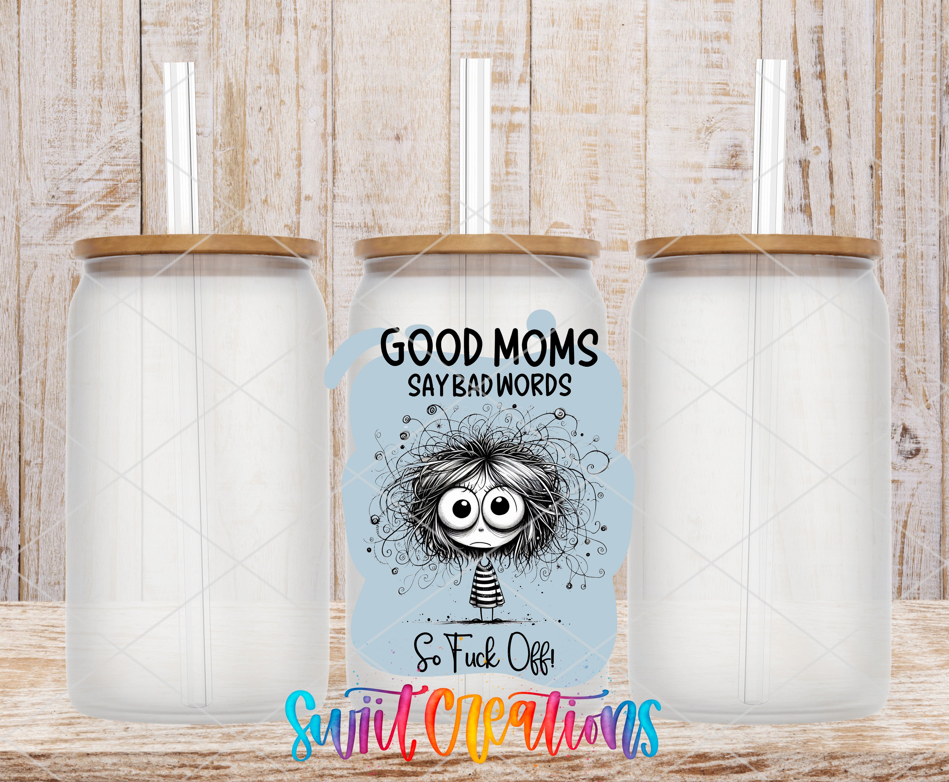 three clear glass jars with wooden lids, each with a straw, and a colorful graphic design on the front of one of the jars.