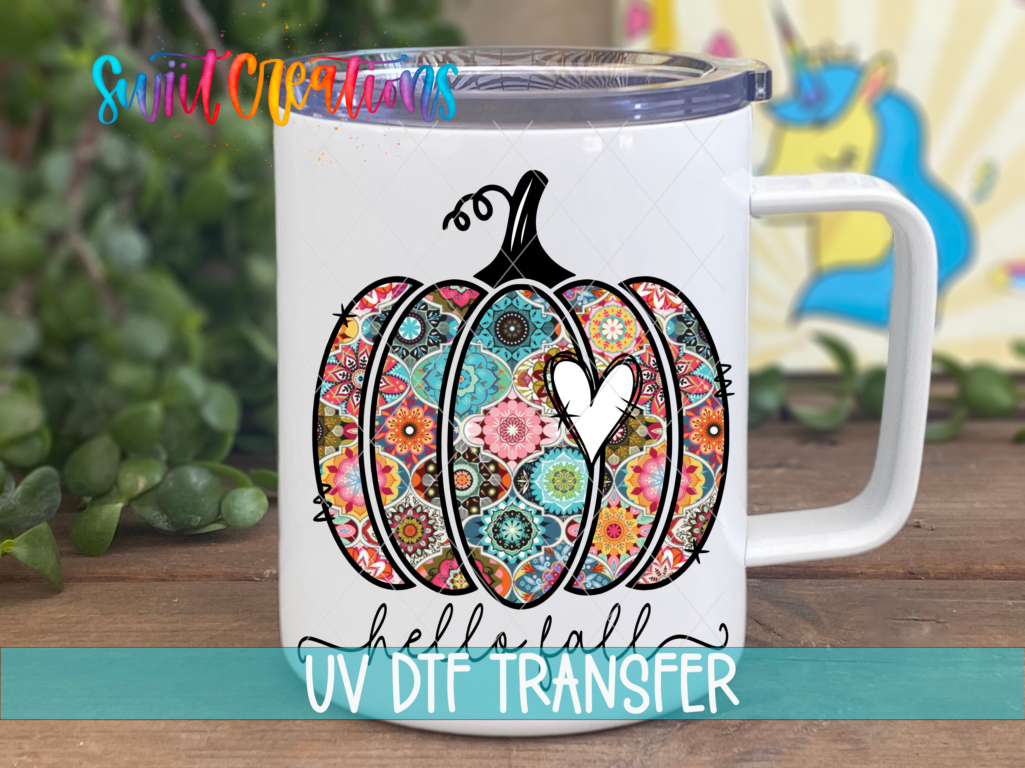 A white ceramic mug with a colorful pumpkin design and the text "Hello! UV Dtf Transfer" printed on it.