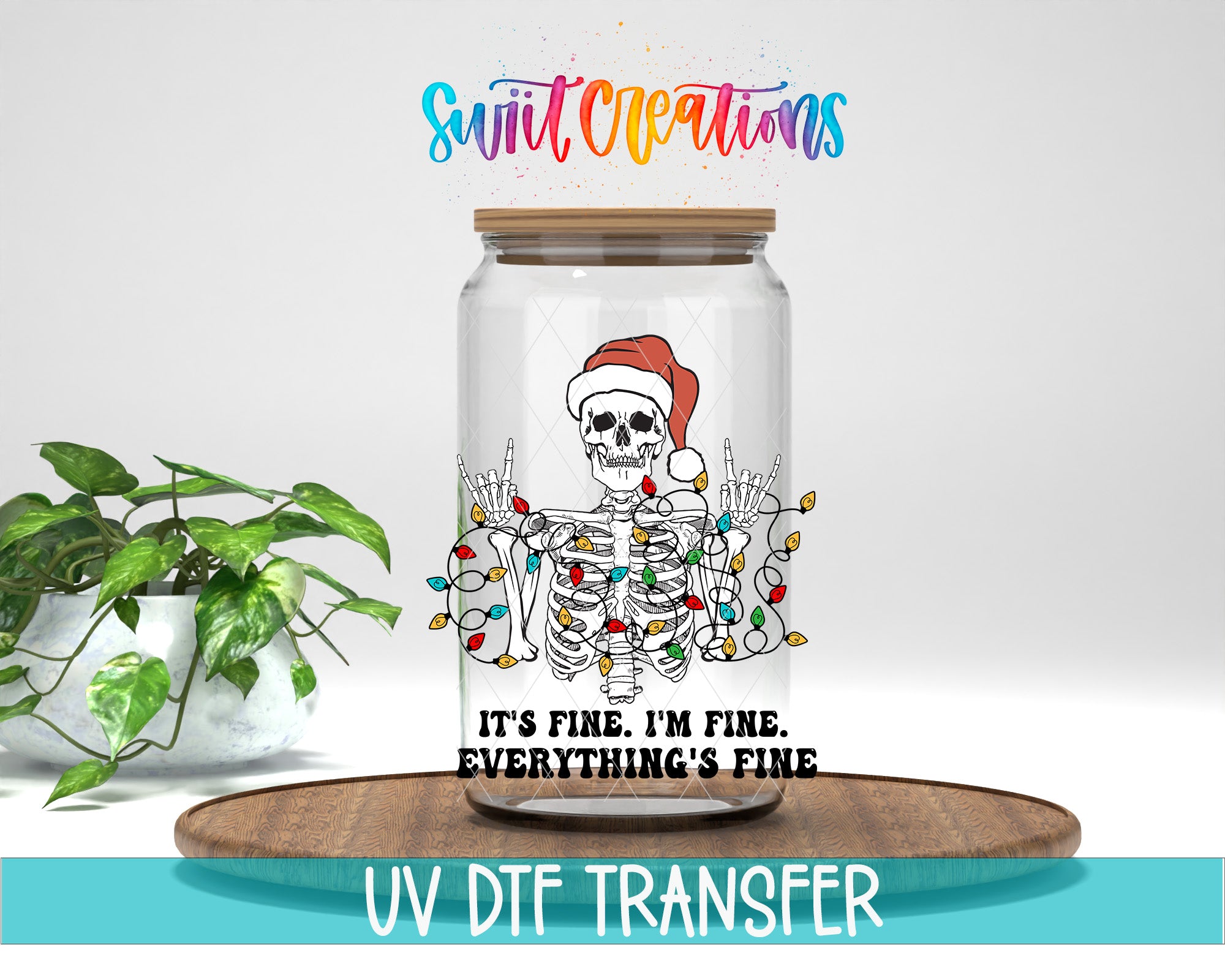 A glass jar with a skeleton wearing a Santa hat and surrounded by colorful lights, accompanied by the text "It's fine, I'm fine, everything's fine" and "UV DFT TRANSFER".