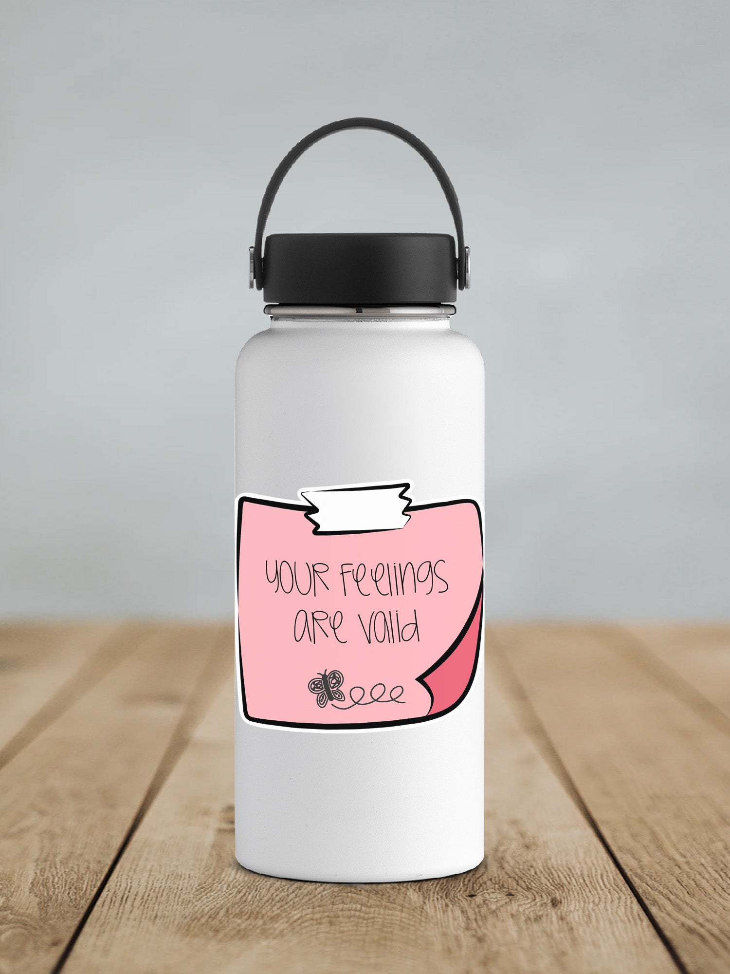 a white water bottle sitting on top of a wooden table