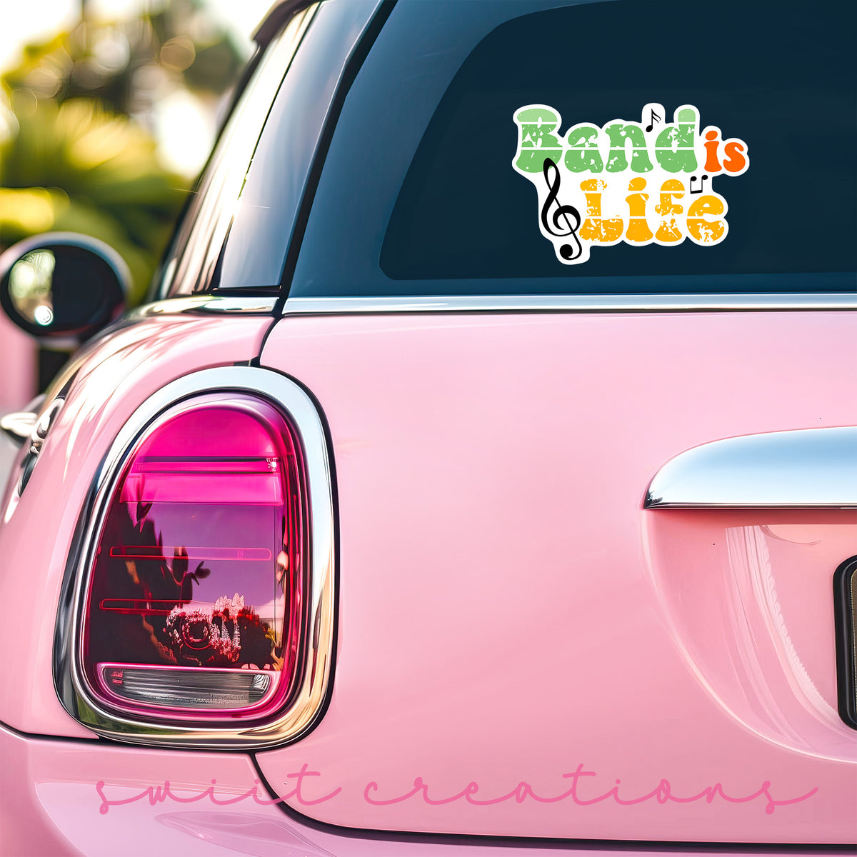 a pink car that has a sticker on it