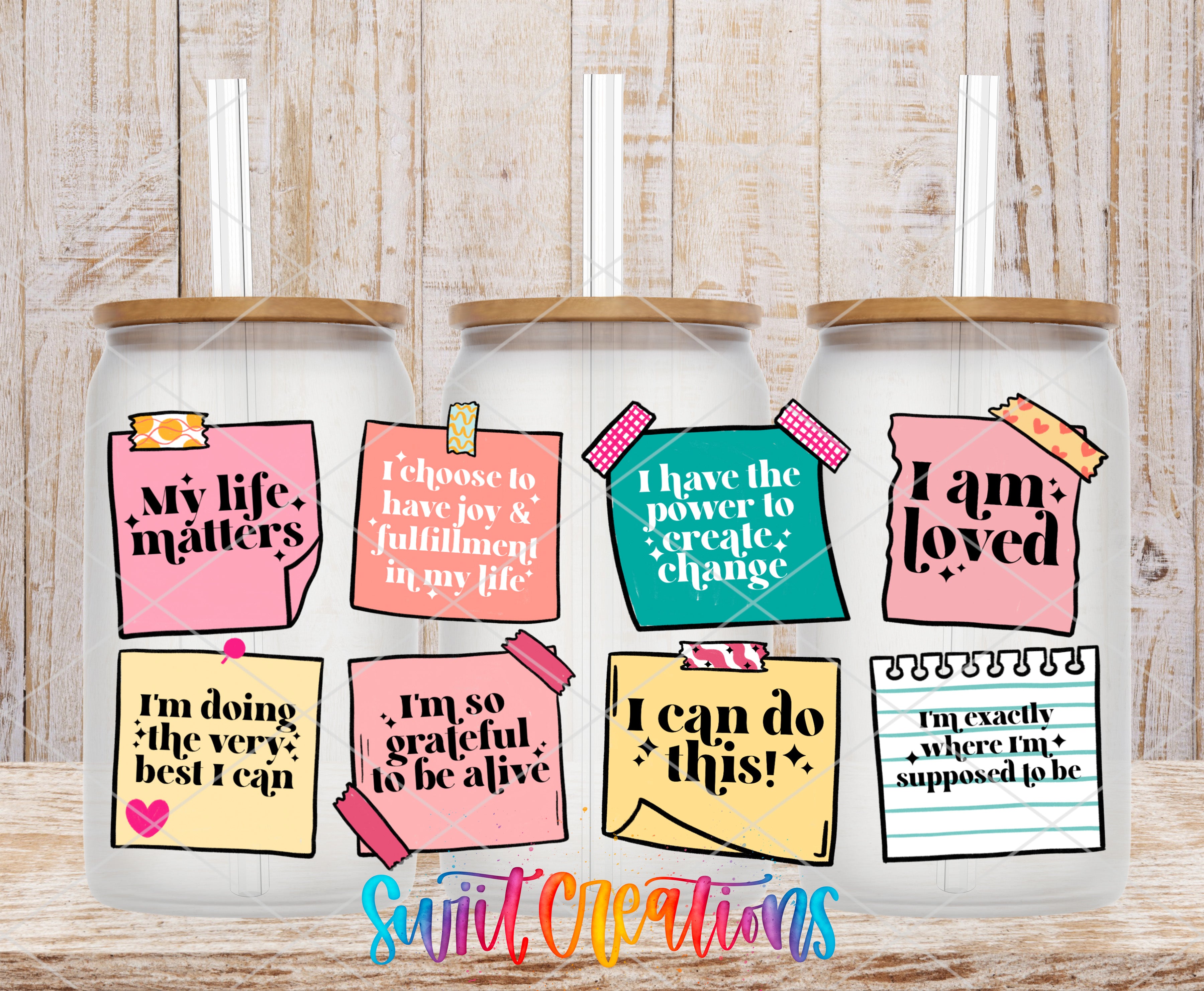 three glass jars with colorful stickers on them, each containing a motivational quote or message.