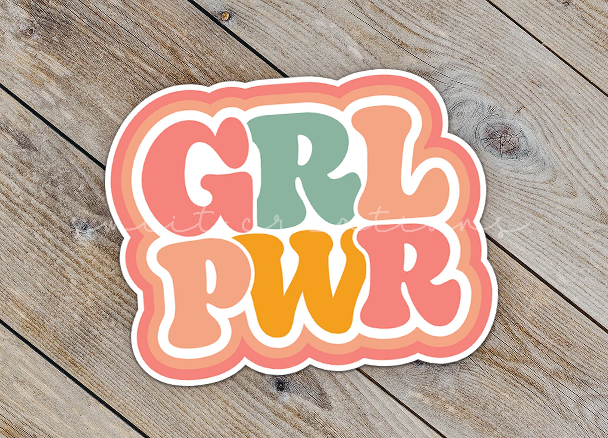 a sticker that says girl power on a wooden surface