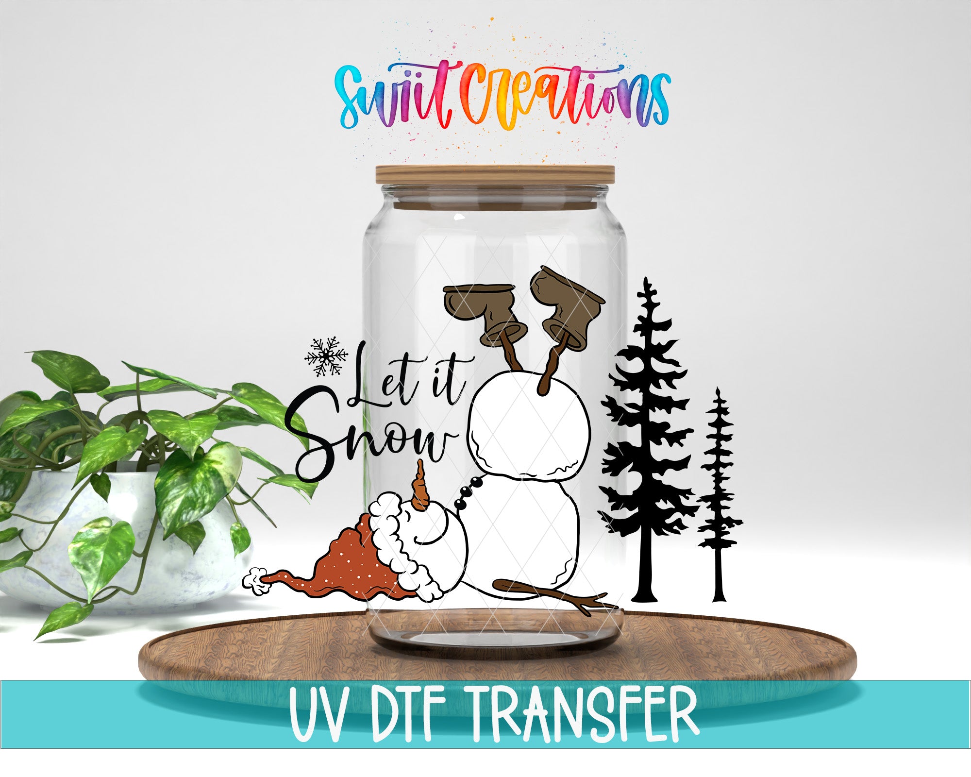 A glass jar with a snowman and pine trees on it, along with the text "Let it Snow" and a colorful logo. The jar is placed on a wooden surface, and there is a potted plant in the background.
