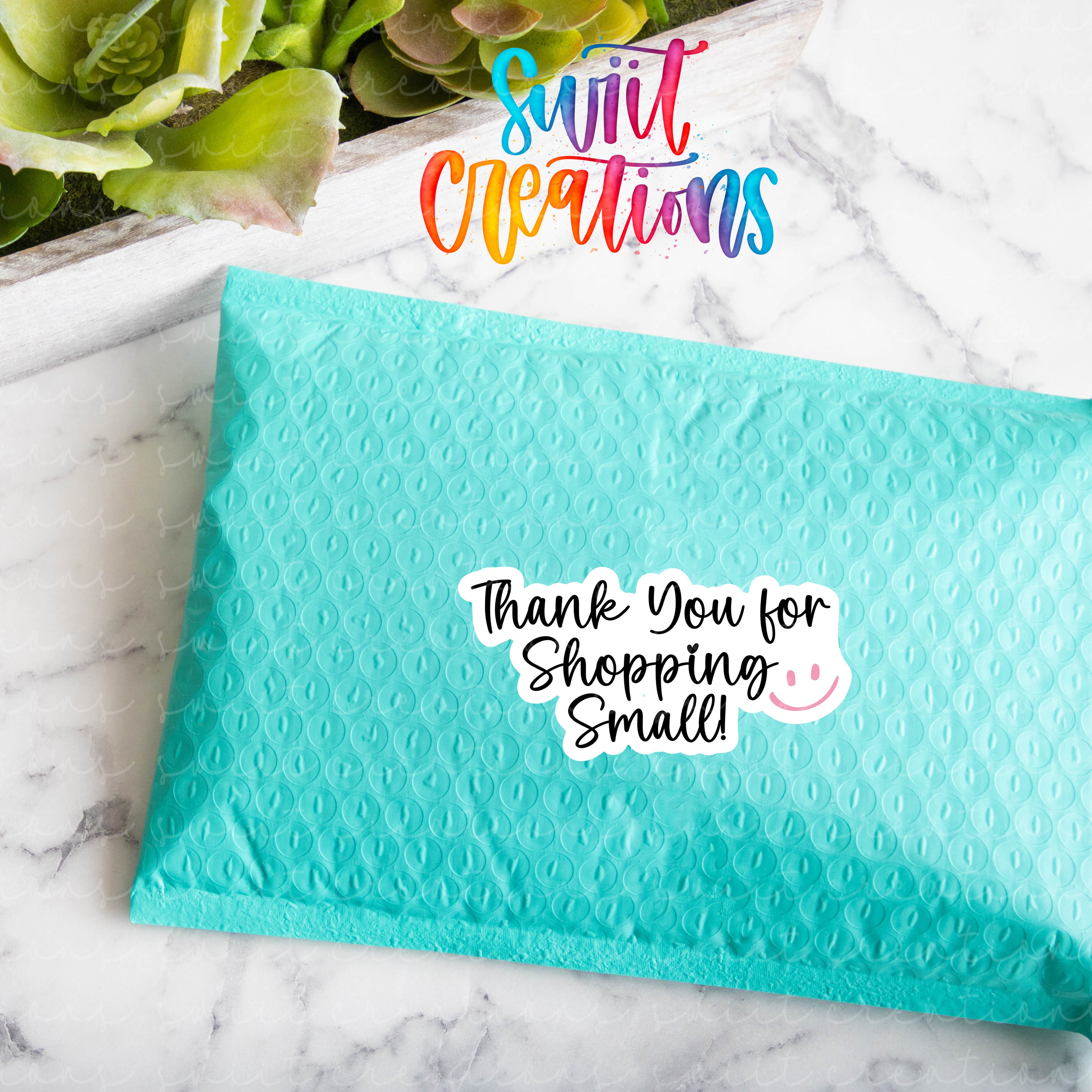a blue envelope with a thank you for shopping smell written on it