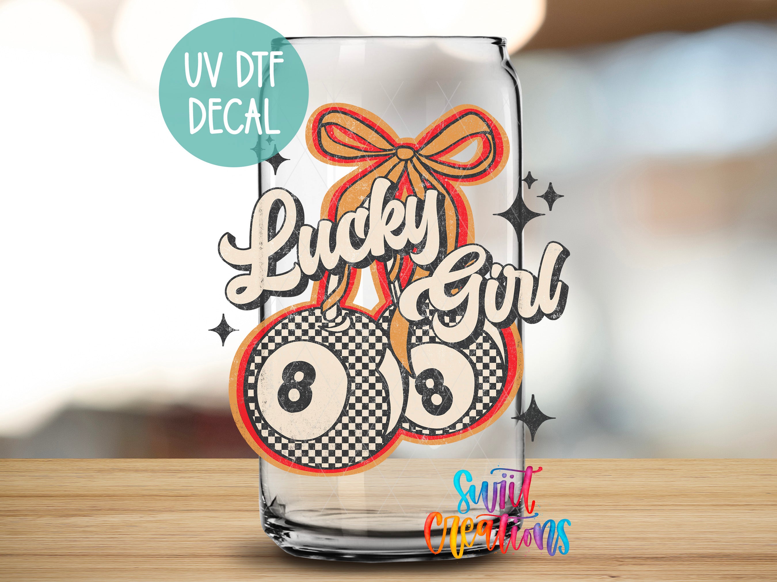 A glass can with a UV decal featuring a cartoon character and text, placed on a wooden surface.