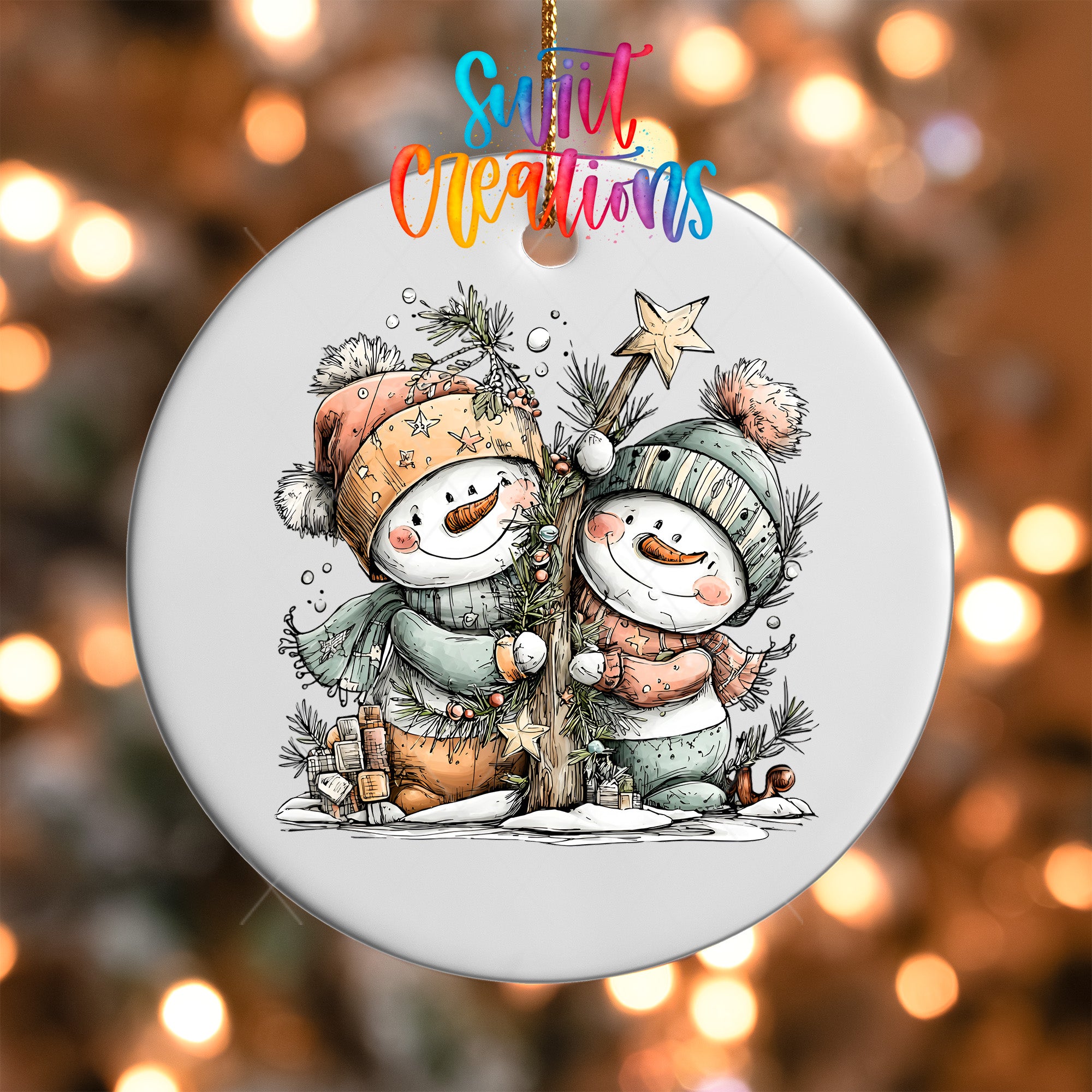A snowman ornament with two snowmen, one wearing a green hat and the other wearing a pink hat, standing next to a tree and holding a star.