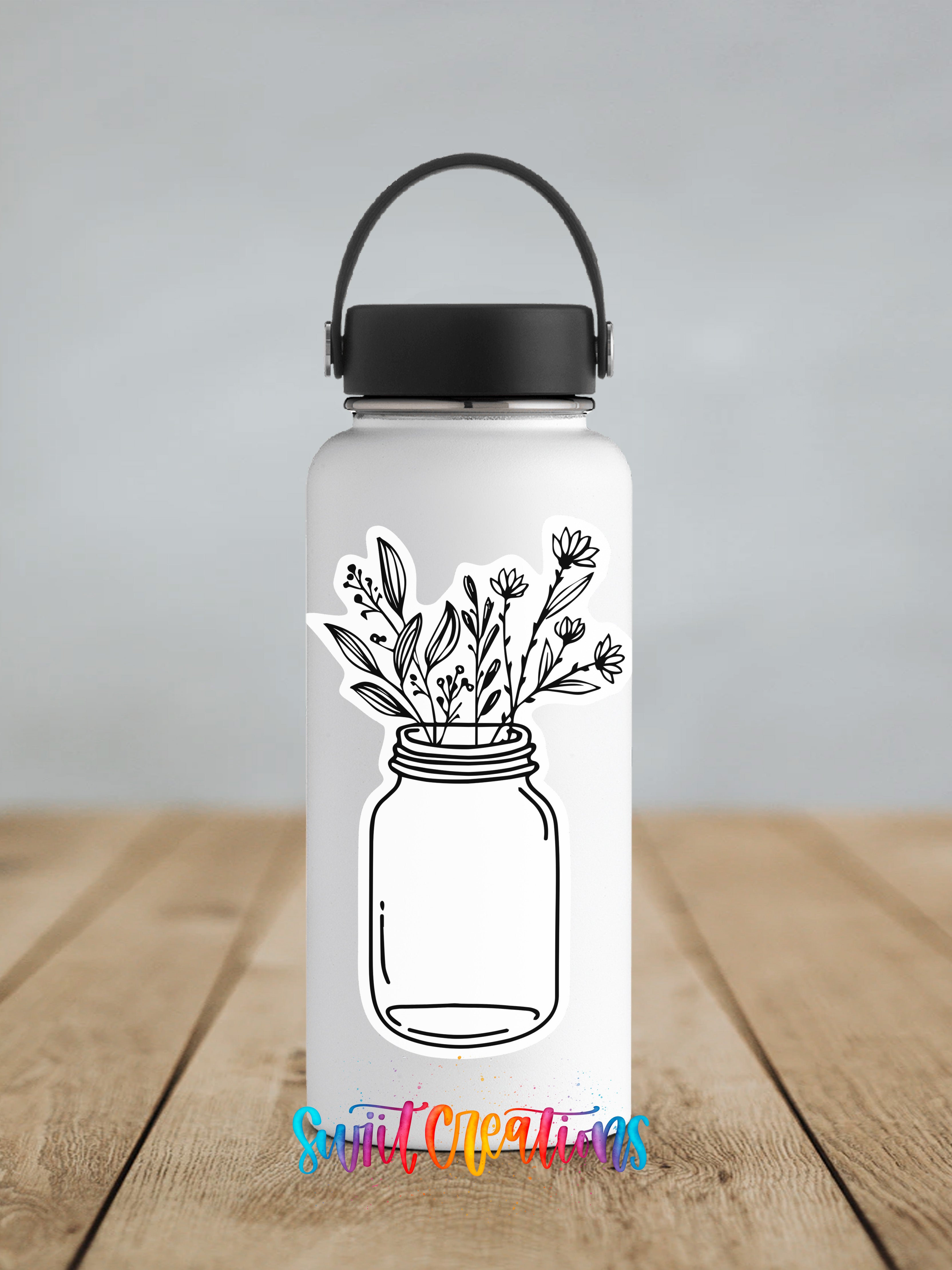 A white water bottle with a black handle and a sticker depicting a mason jar filled with flowers and leaves.