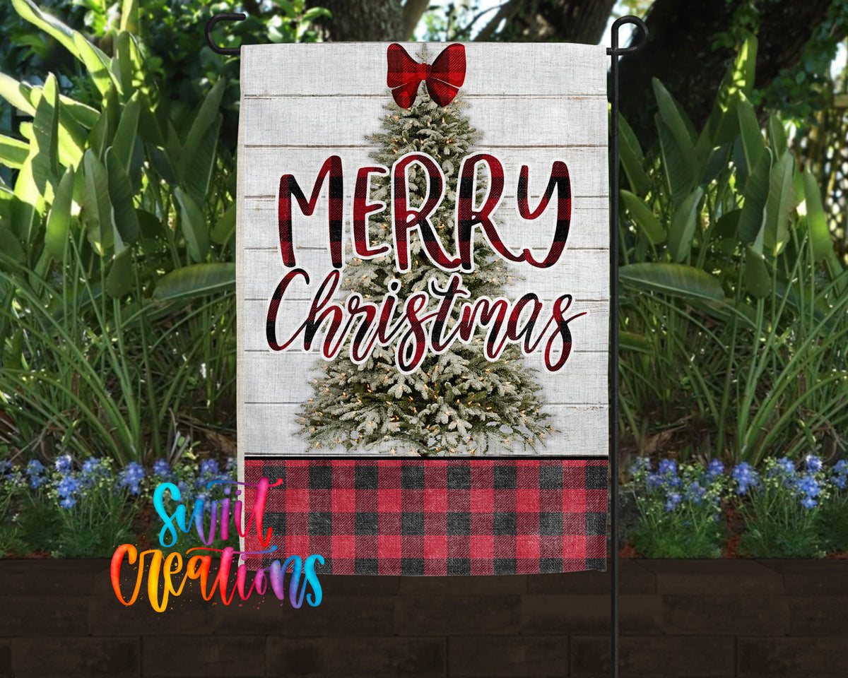 A white garden sign with a Christmas tree design and the text "MERRY CHRISTMAS" displayed in a festive style.