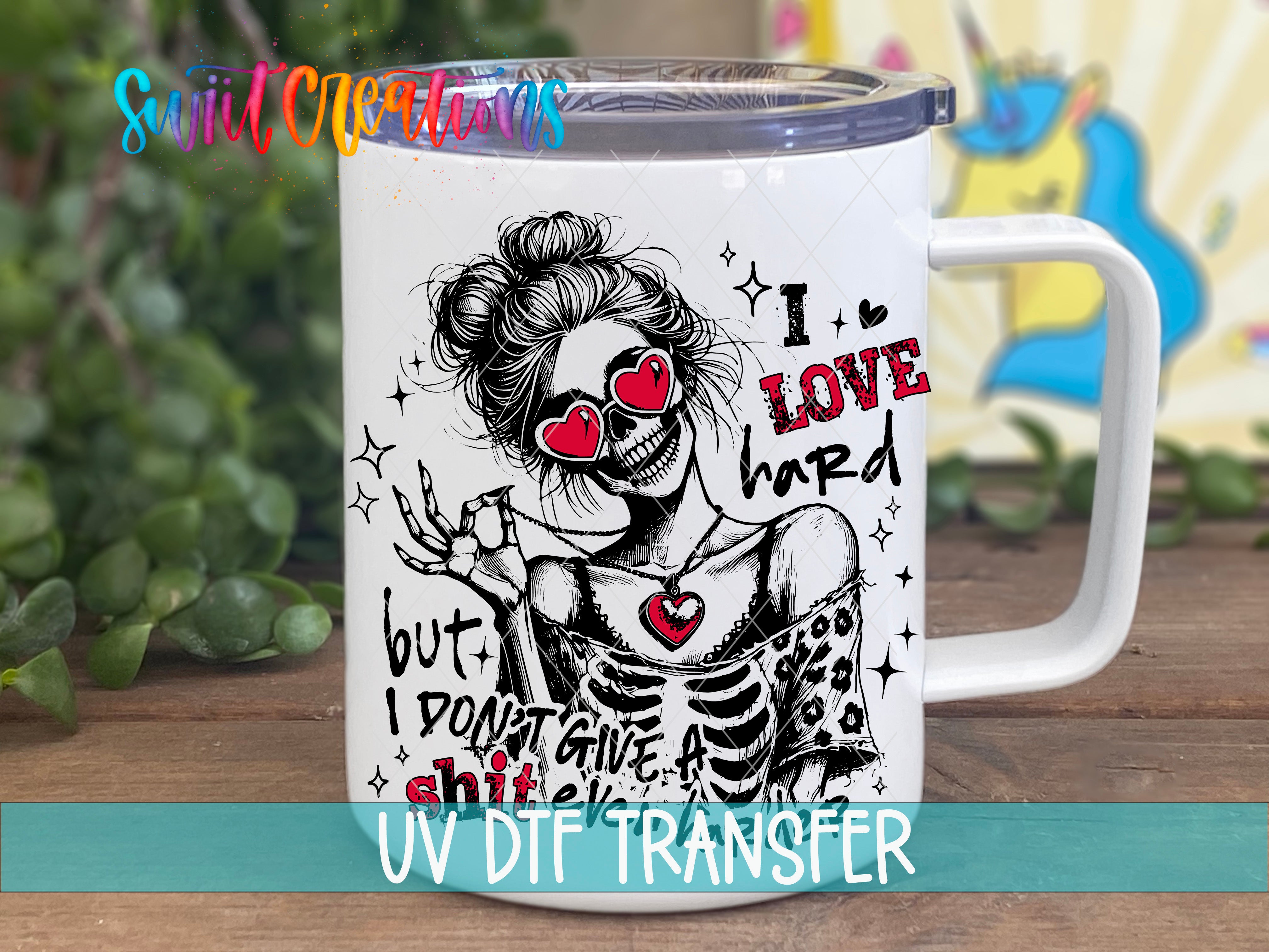 A white mug with a black and red graphic design featuring a skeleton wearing sunglasses and the text "I LOVE HARD" along with other text and symbols.