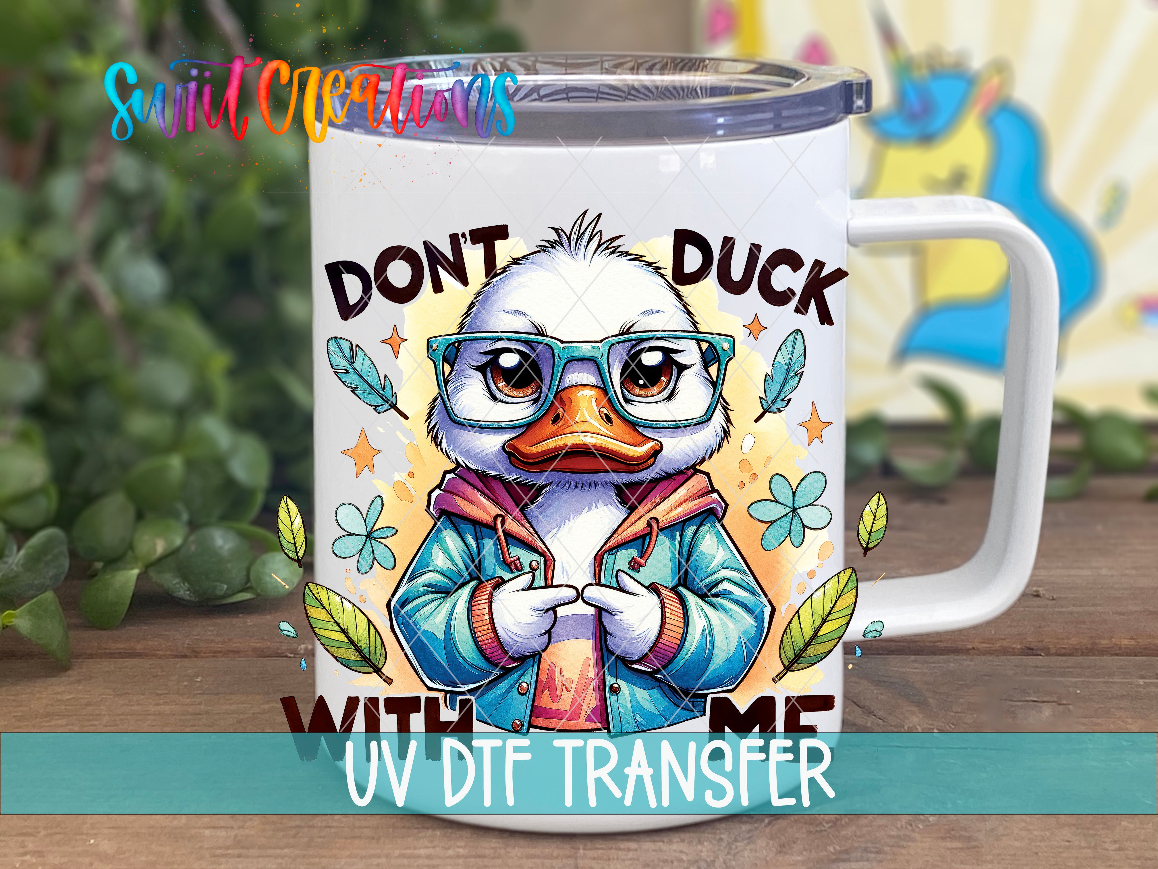 A mug with a cartoon duck wearing glasses and a jacket, along with the text "DON'T DUCK WITH ME" and "UV DFT TRANSFER".
