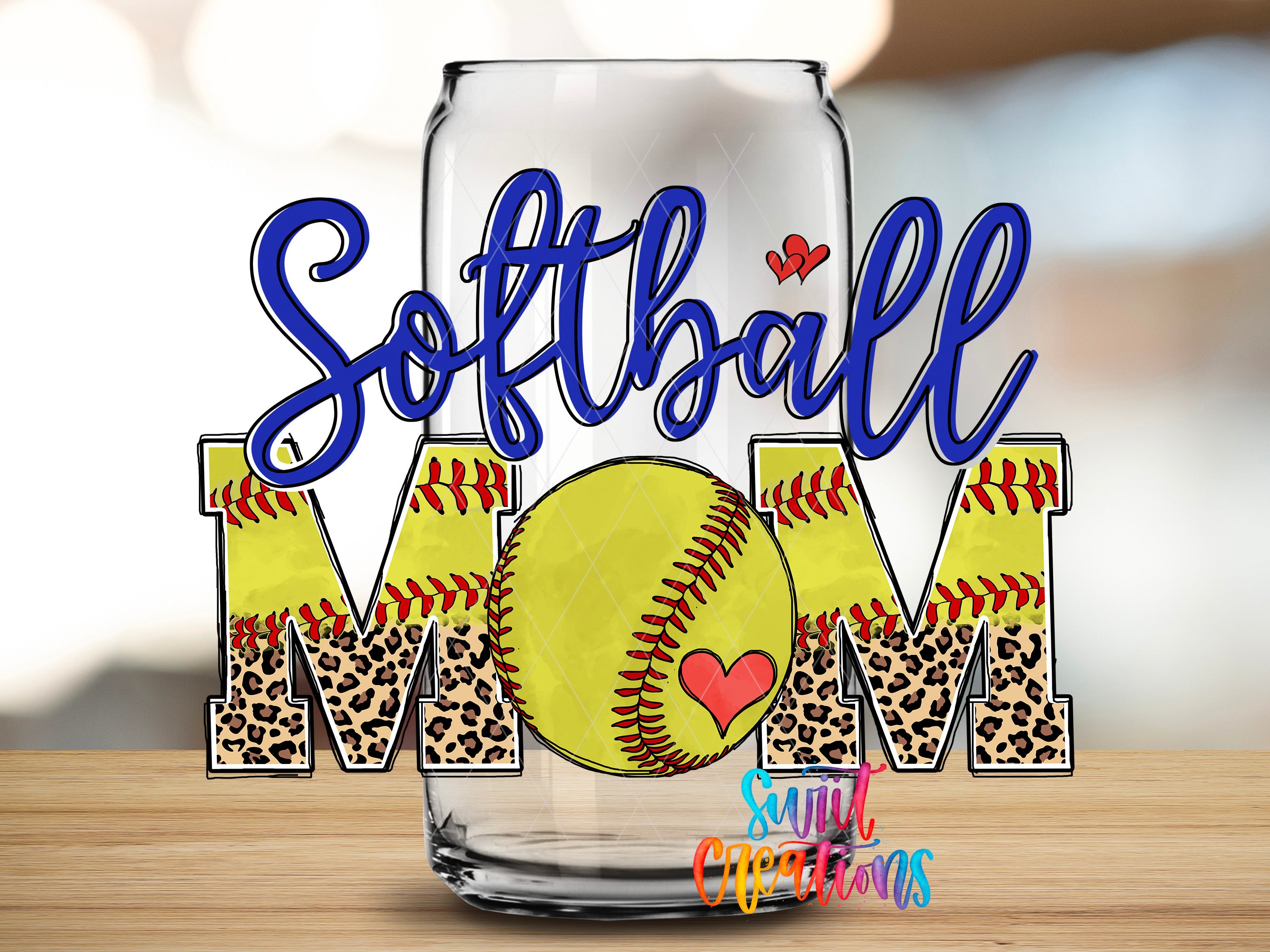 A glass with the word "Softball Mom" written on it, along with a leopard print design and a heart symbol.