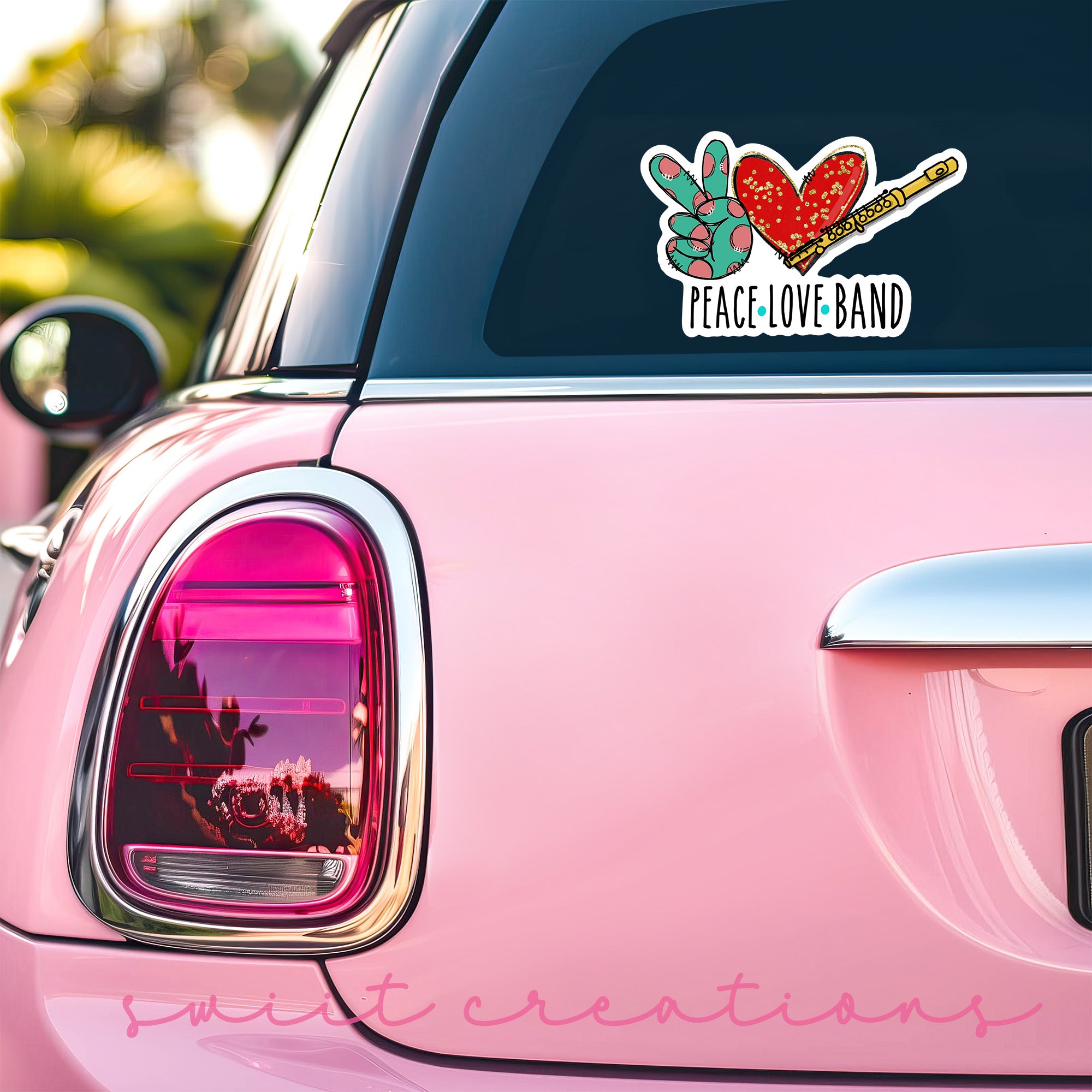 a pink car with a peace love band sticker on it