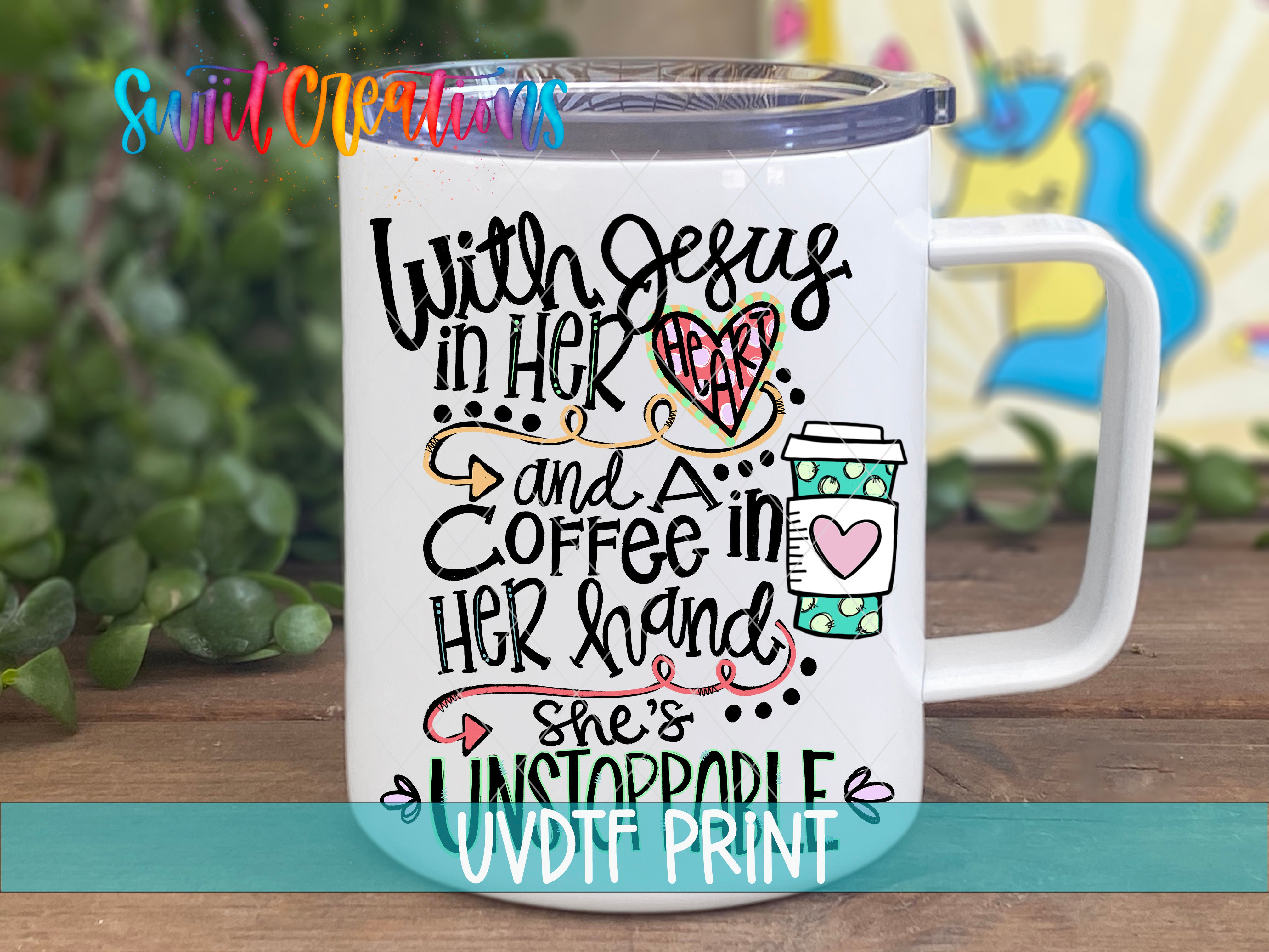 A white ceramic mug with colorful text and illustrations on it, placed on a wooden surface.