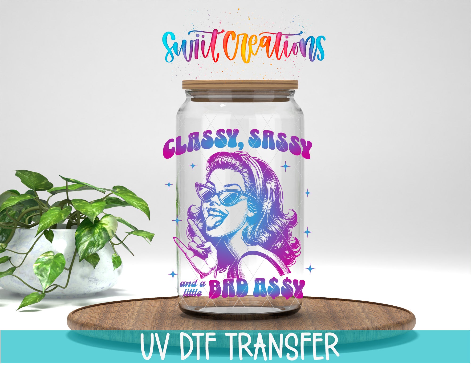a glass jar with a colorful illustration of a woman wearing sunglasses, along with the text "CLASSY, SASSY and a BAD ASSY" printed on it. The jar is placed on a wooden surface, and there is a potted plant in the background.