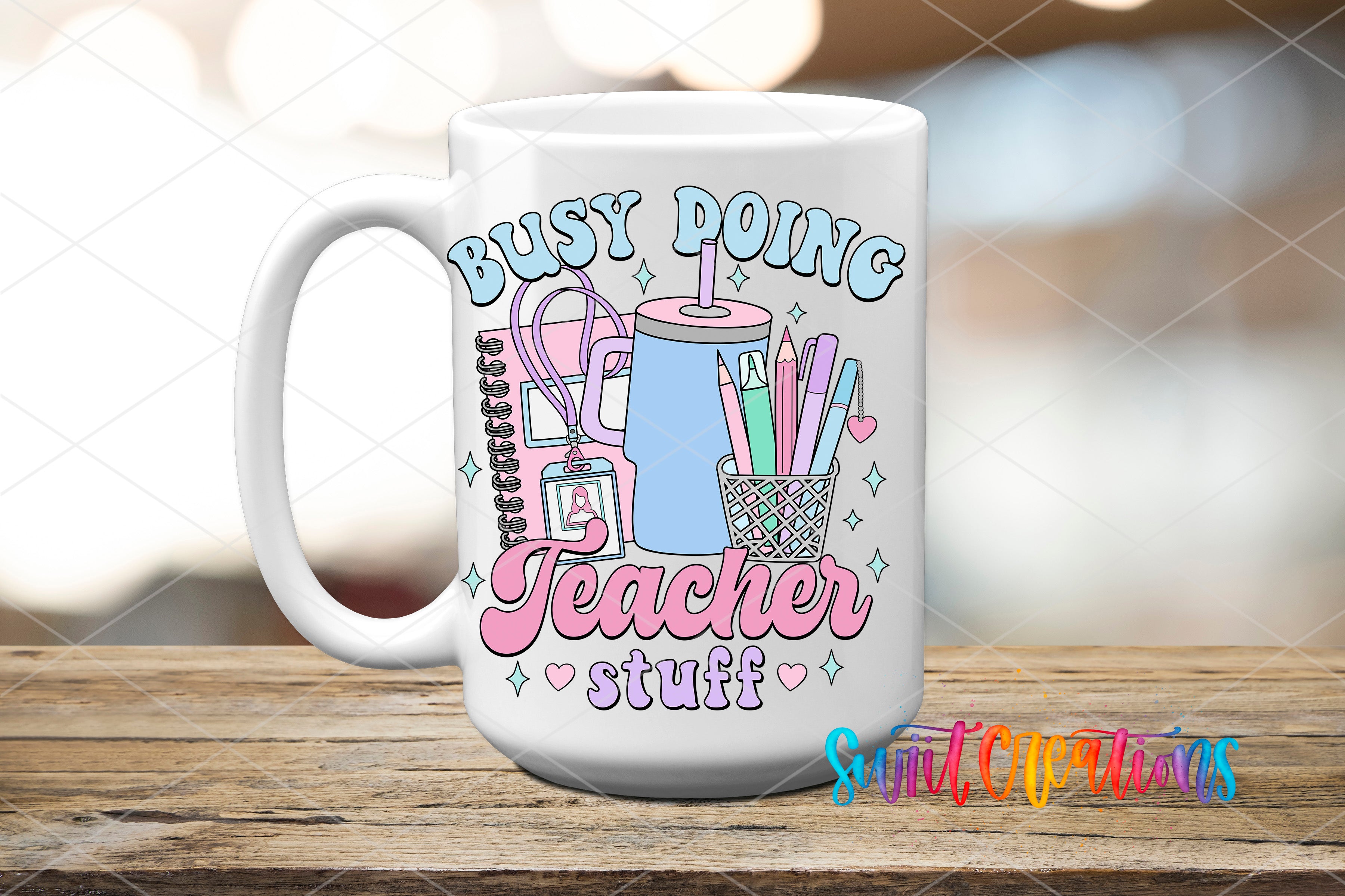 A white ceramic mug with a colorful design featuring various school supplies and the text "Busy doing Teacher stuff" printed on it.
