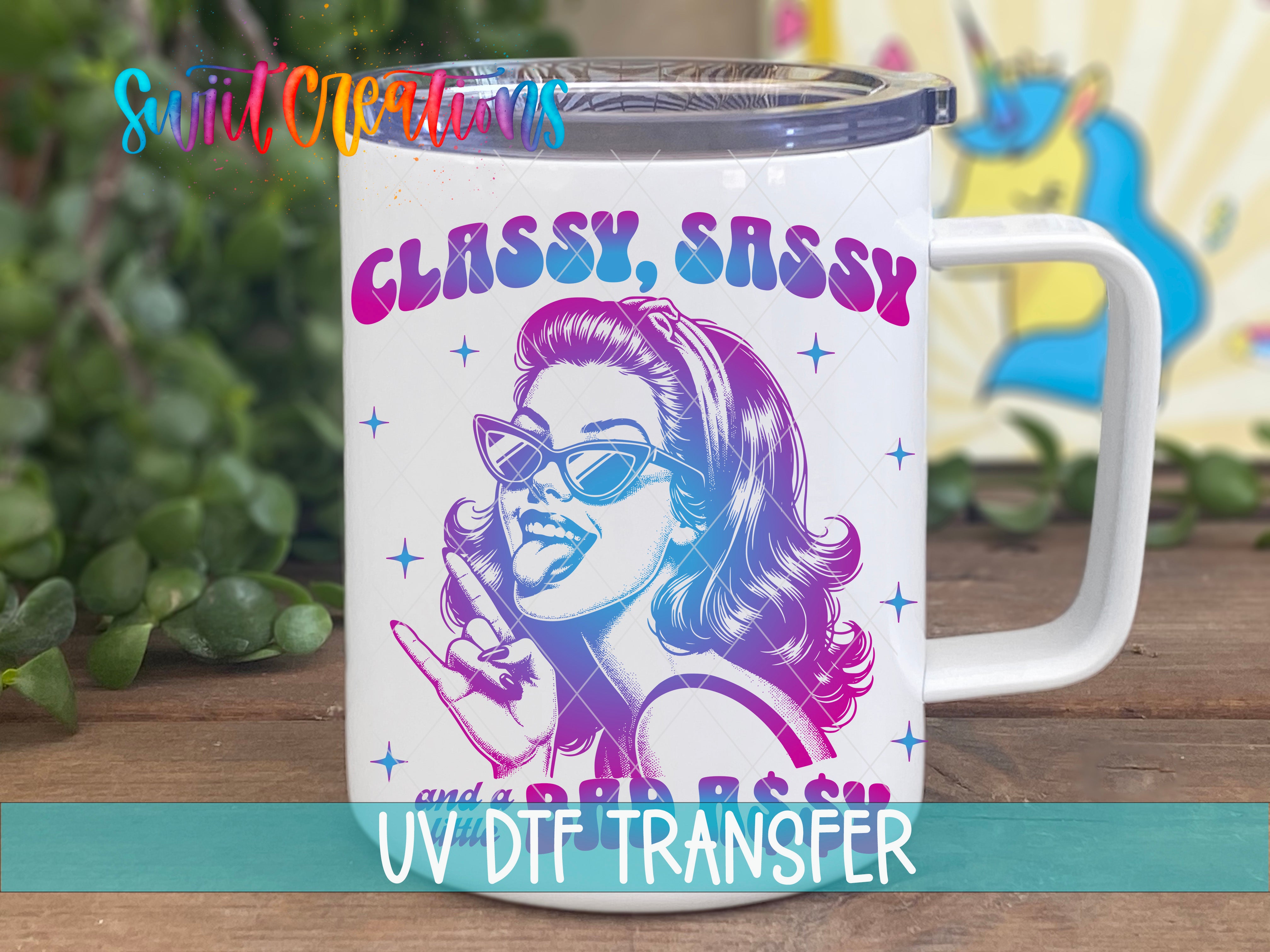 A white mug with a colorful graphic design featuring a woman's face wearing sunglasses and a sassy expression.