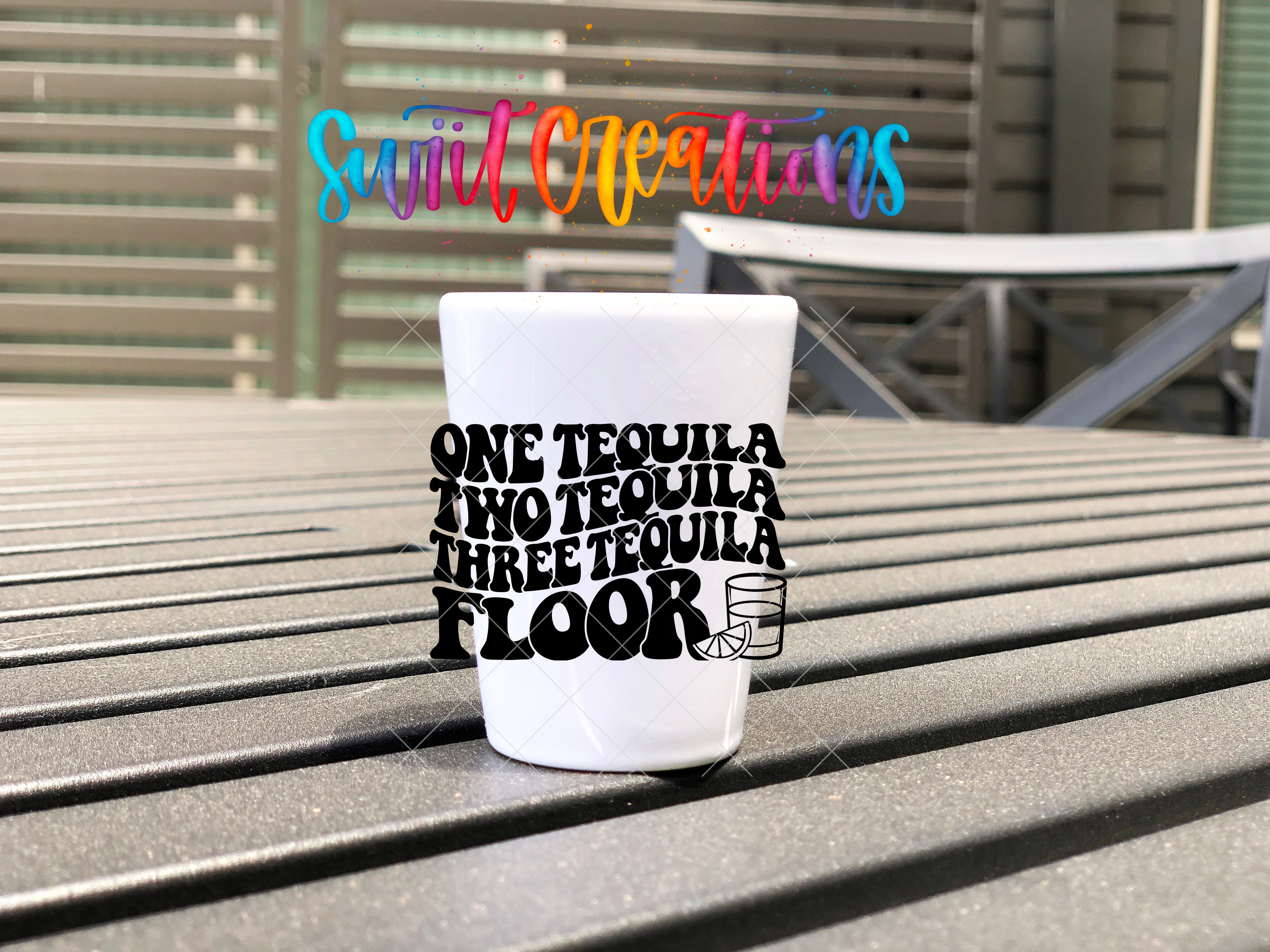 A white cup with text printed on it, placed on a wooden surface.