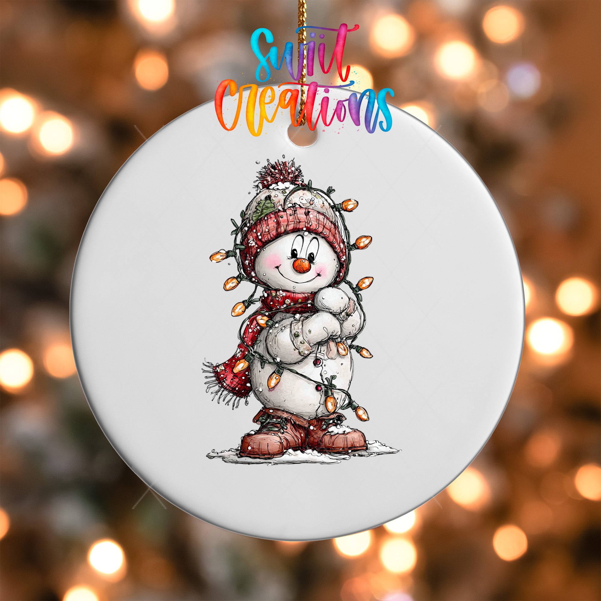 A snowman ornament with a scarf and hat, and a string of lights around its neck, is hanging against a background of blurred lights.