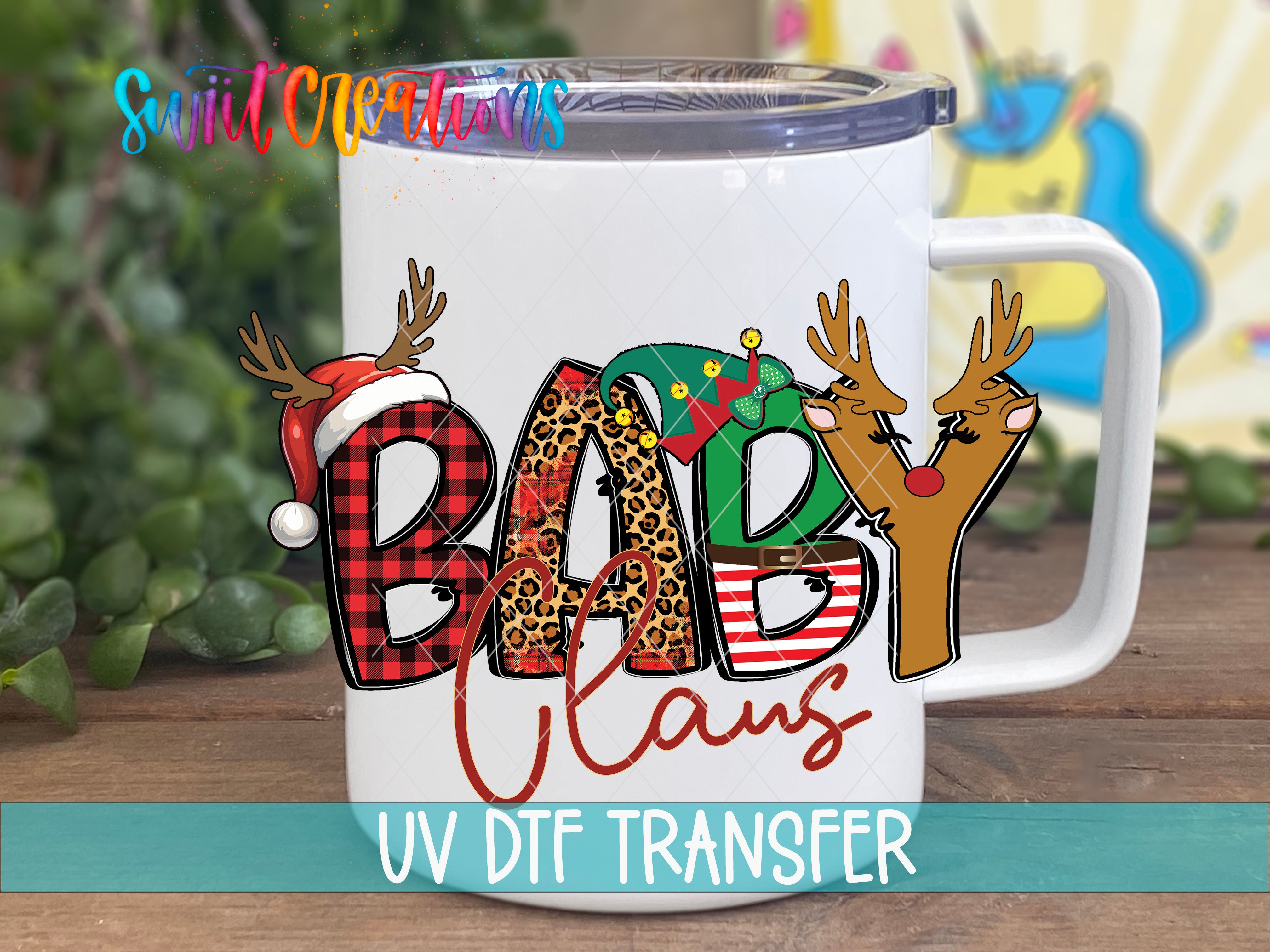 A white mug with a colorful design featuring the letters "BABY CLANS" and various holiday-themed elements such as reindeer and snowmen.