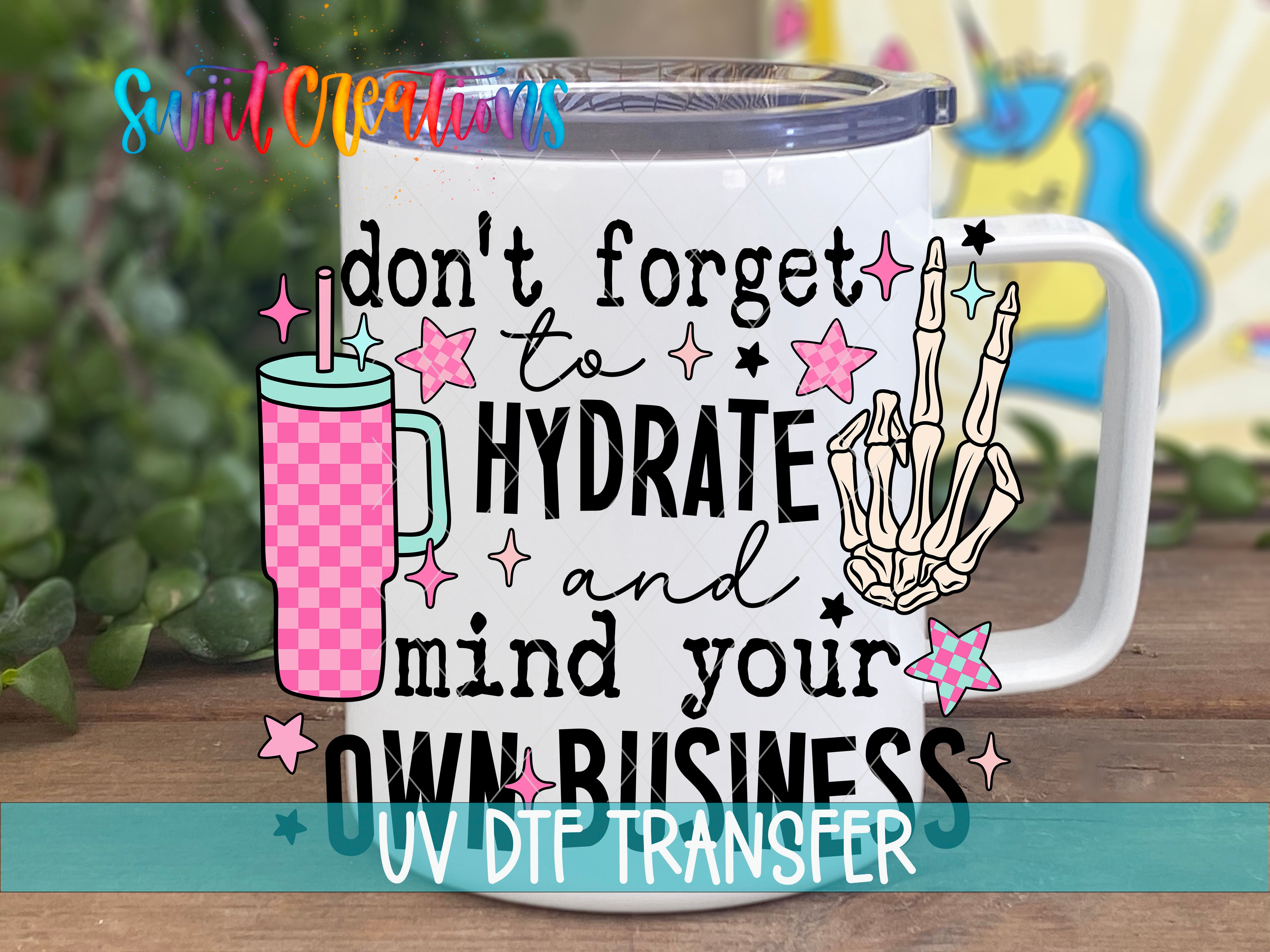 A white mug with a colorful design and text printed on it, placed on a wooden surface.