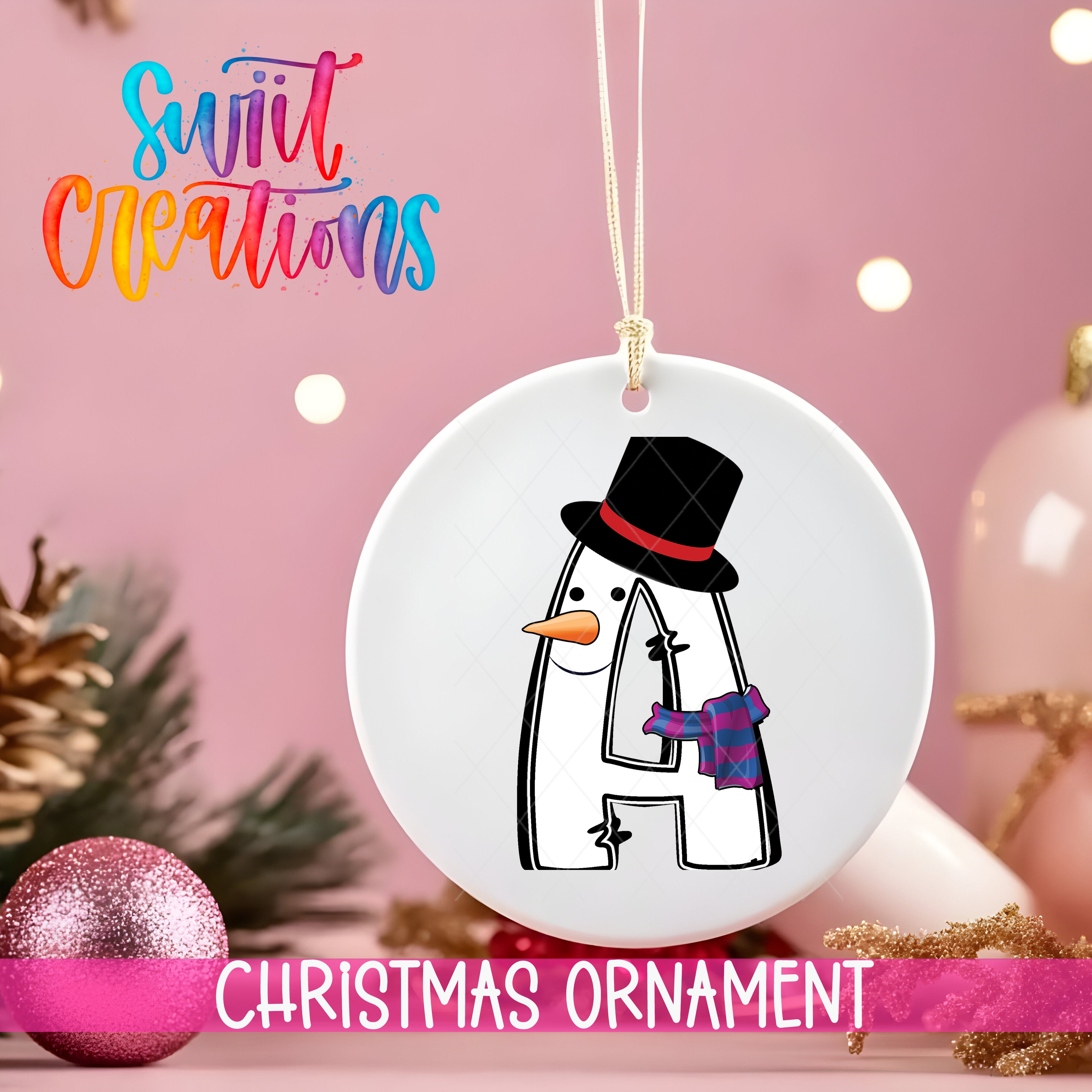 A white Christmas ornament with a snowman design hangs against a pink background.