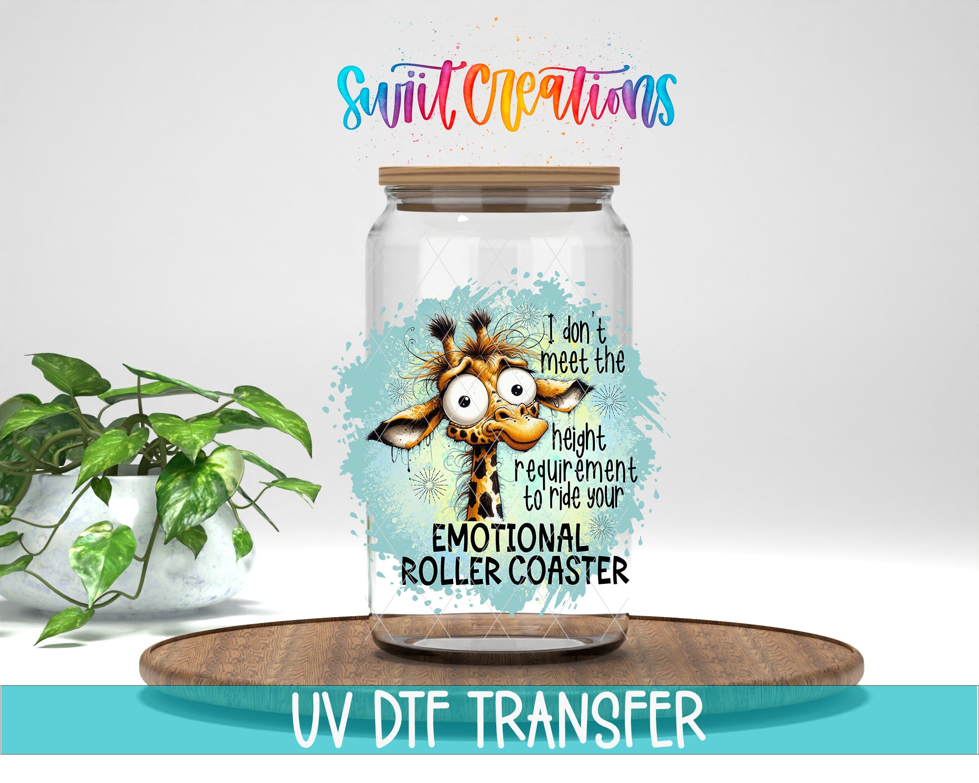 A glass jar with a giraffe design and text, placed on a wooden surface next to a potted plant.