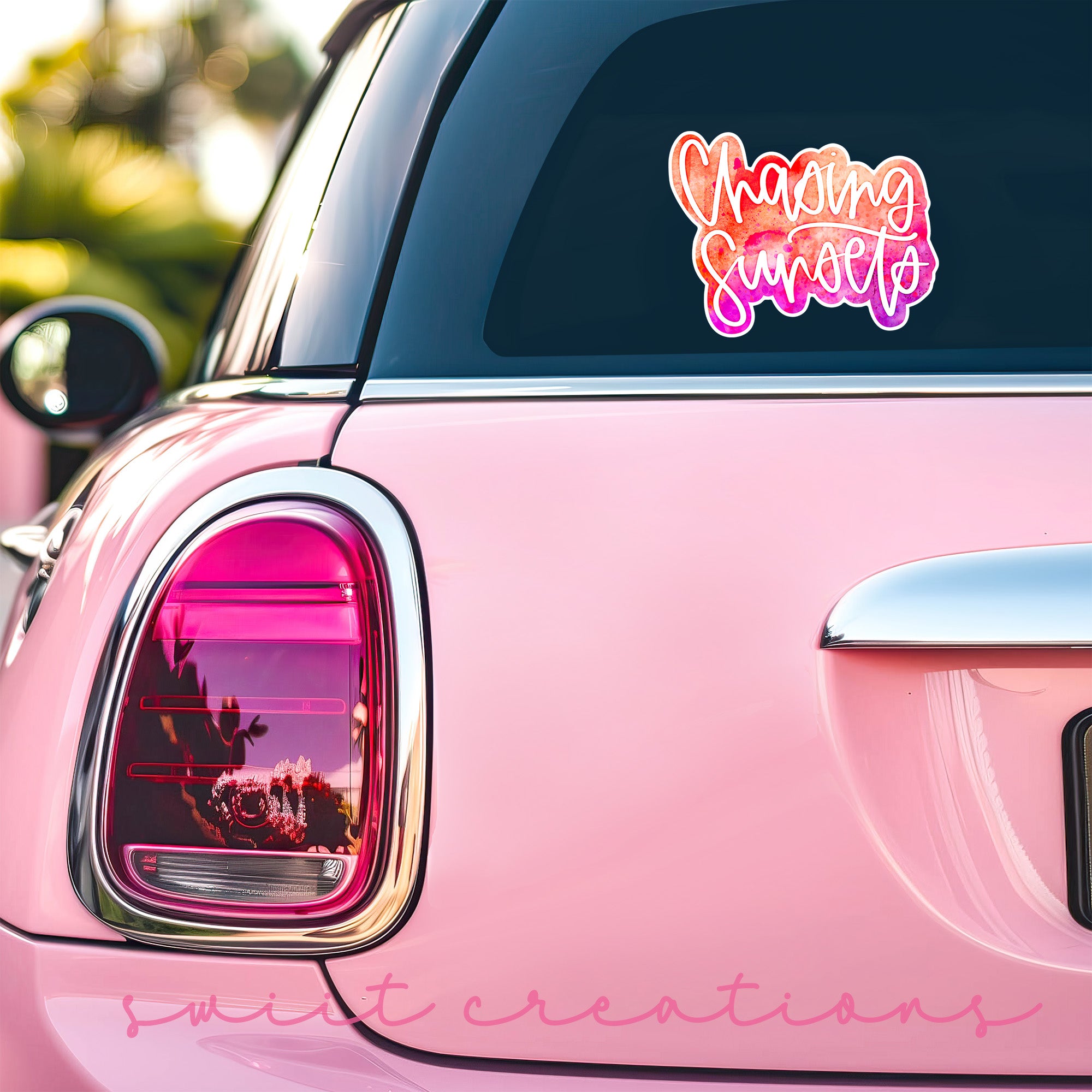 a pink car with a sticker on the back of it