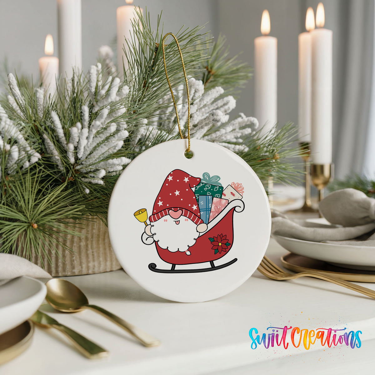 A white ceramic ornament featuring a gnome riding a sled, surrounded by pine branches and candles, placed on a table with other tableware.