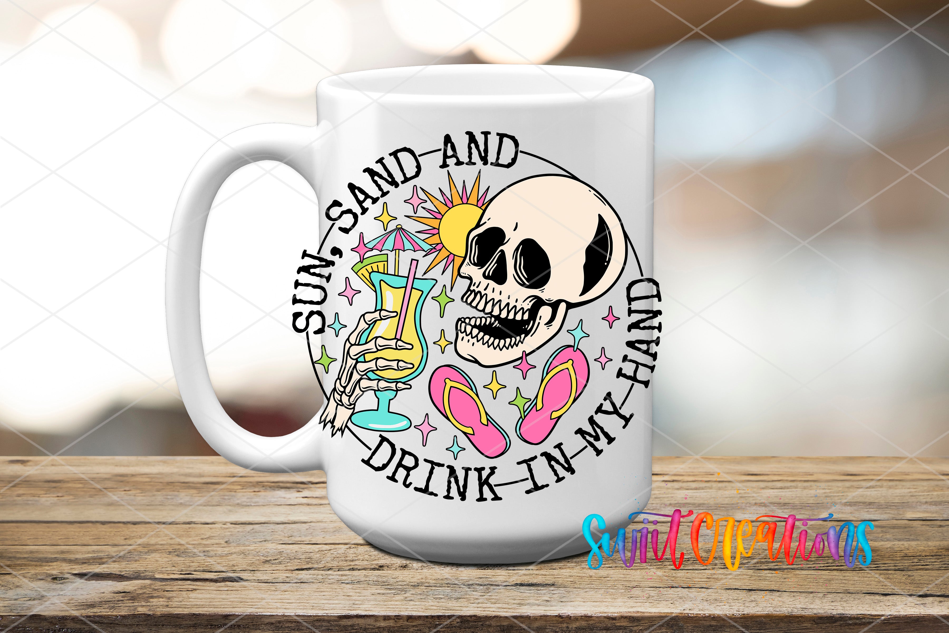 A white ceramic mug with a colorful design featuring a skull, sunglasses, and a beach scene, along with the text "Sun, sand, and drink in my hand".