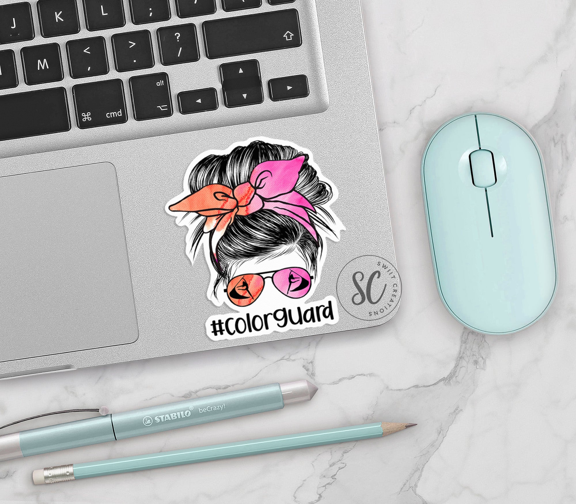 a laptop with a sticker of a woman with a pink bow